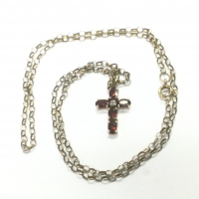 A 9ct gold cross and chain set with garnets, possibly rubies, approx 3.6g. Shipping category A.
