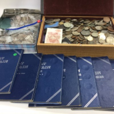 Two boxes of British and foreign currency including many silver coins. Shipping category D.