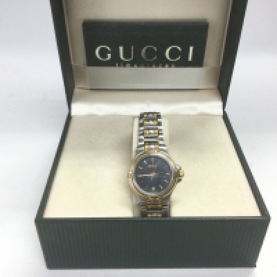 A boxed Gucci two tone watch with booklet. In full working order. Shipping category B.