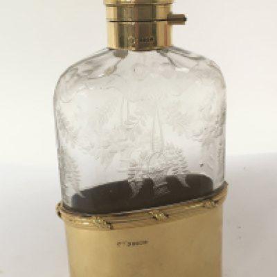 An Exceptional Quality 18carat gold and wheel etched glass George V hip flask date 1919. One of the finest hip flasks to be sold on the market. The hallmark for London with George V crown maker Finnigans New Bond Street London. Which had many famous customers Rockefeller Ford Vanderbilts. The hip flask with a solid 18carat gold collar and hinged top. The base cup solid 18carat gold weight 92g the collar possible a further 40g. No damage. No personal inscriptions.