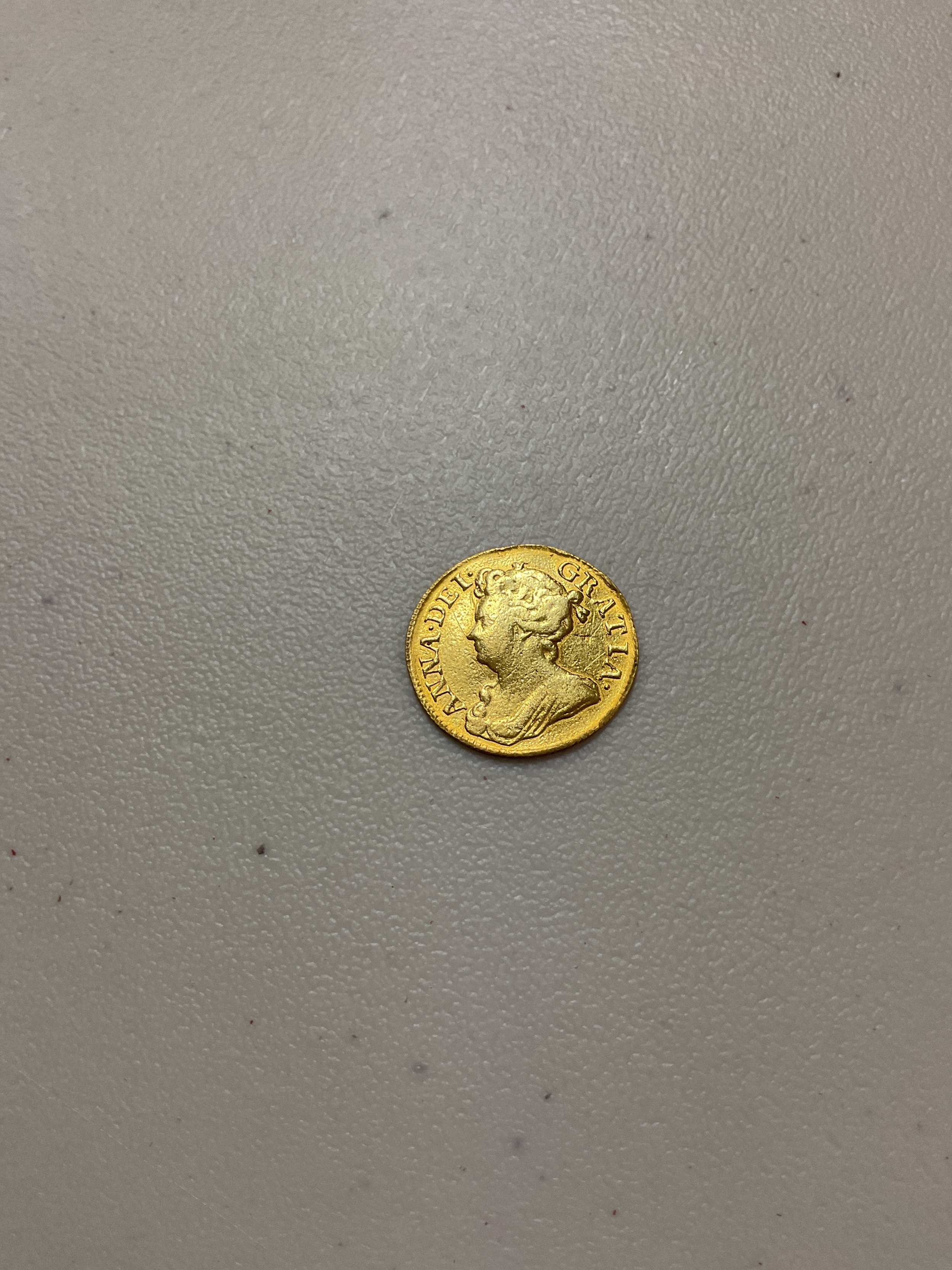 1714 Queen Anne Guinea, weight 8.1 grams.