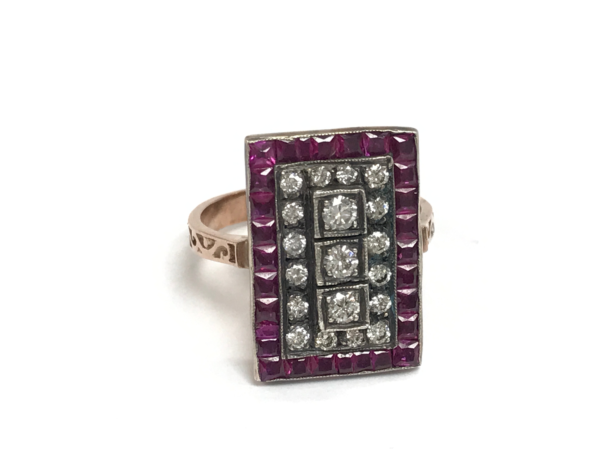 An 8ct rose gold art deco style panel ring set with a cluster of diamonds and a boarder of square synthetic rubies. Diamonds approx 0.65ct and rubies approx 0.65ct. Size P