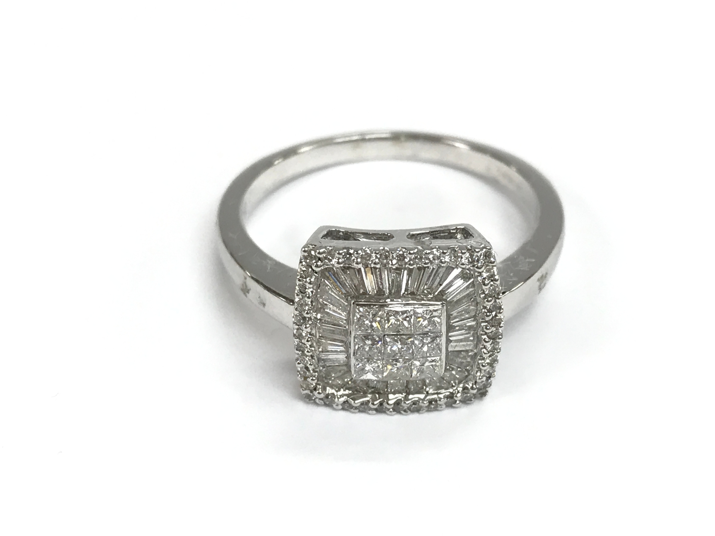 An 18ct white gold square shaped ring set with baguette and round cut diamonds. Approx 0.86ct
size R 1/2