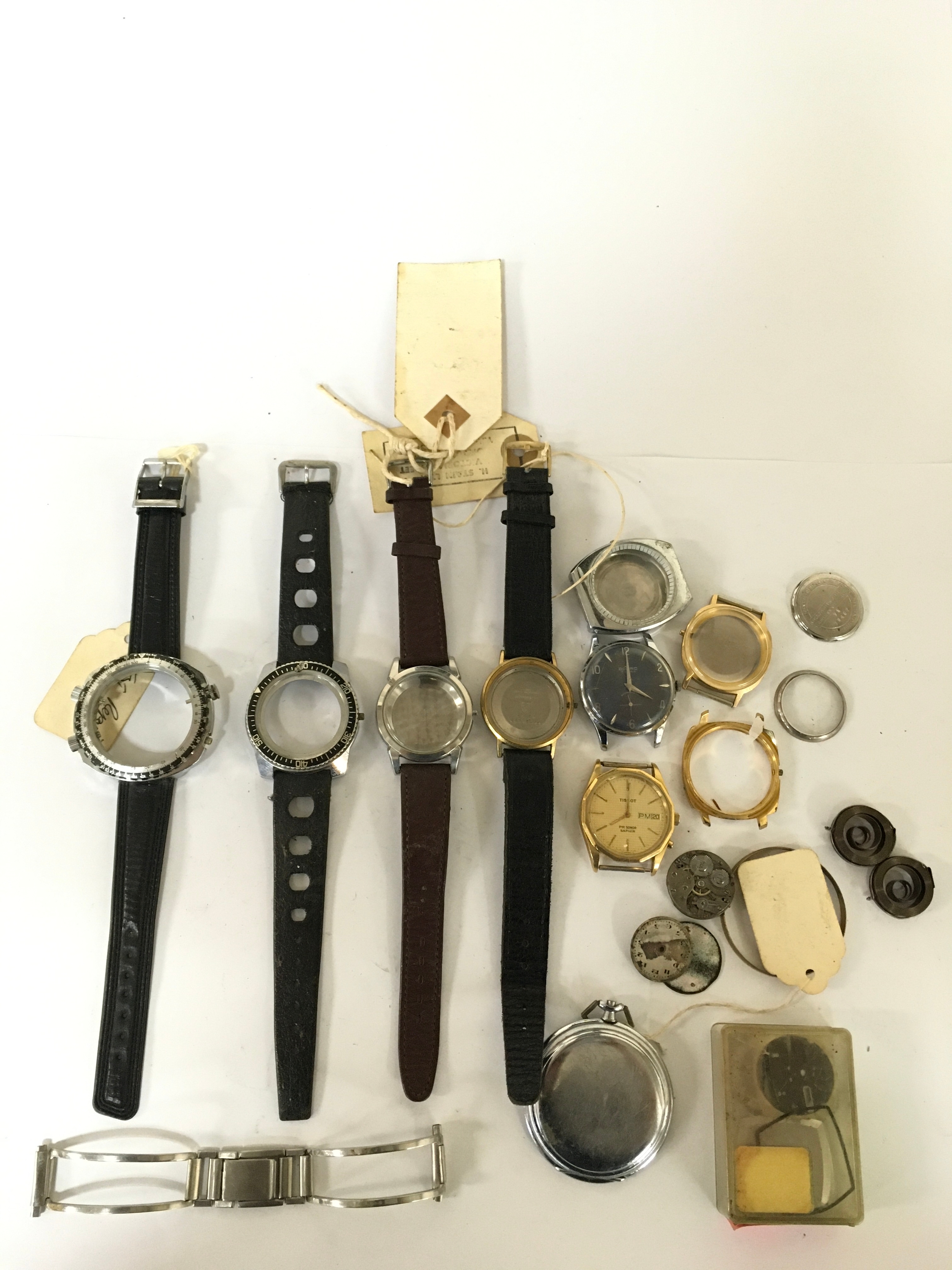 A vintage Omega watch case on leather strap, plus various other watch faces including chronograph examples