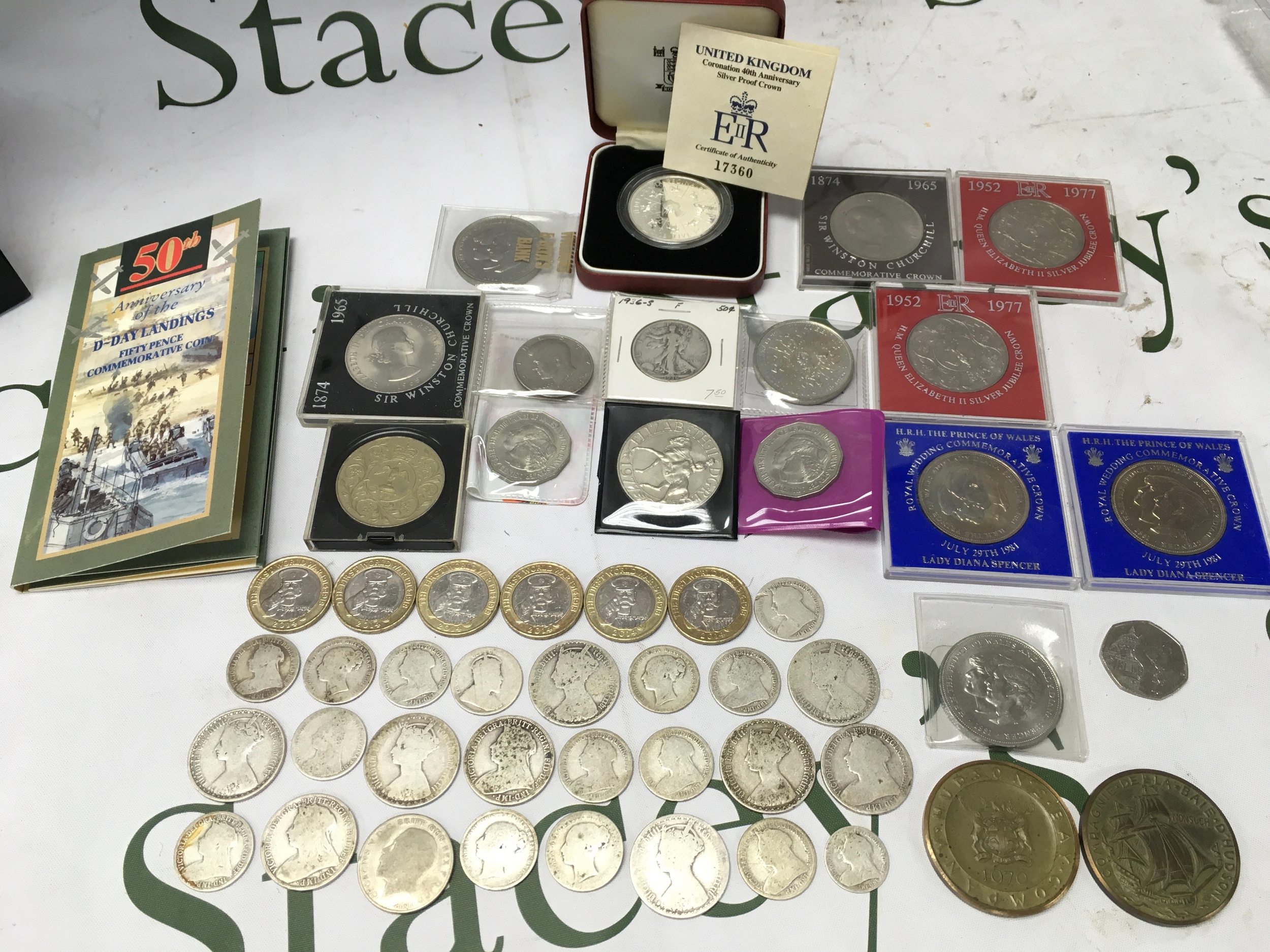 A tin of Victorian and later coins including a silver proof crown, half dollar, two pound WW1 coins, shillings, florrins etc 