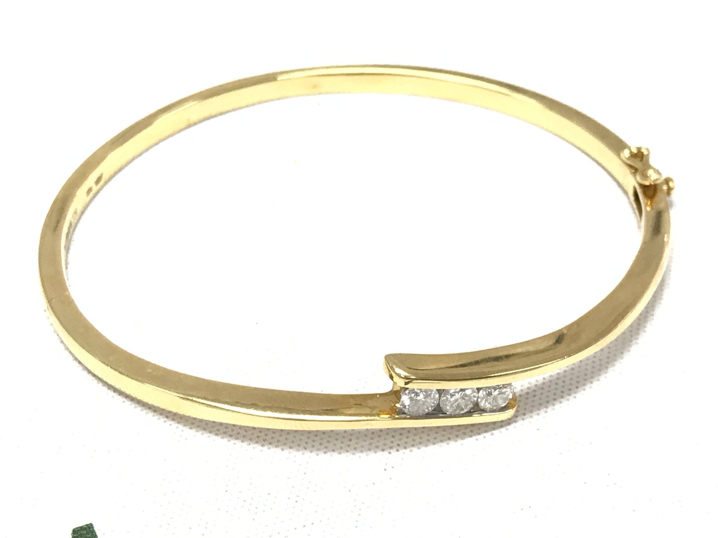 An 18ct gold diamond bangle with a certificate. 6.5cm wide, 22.6g total weight 