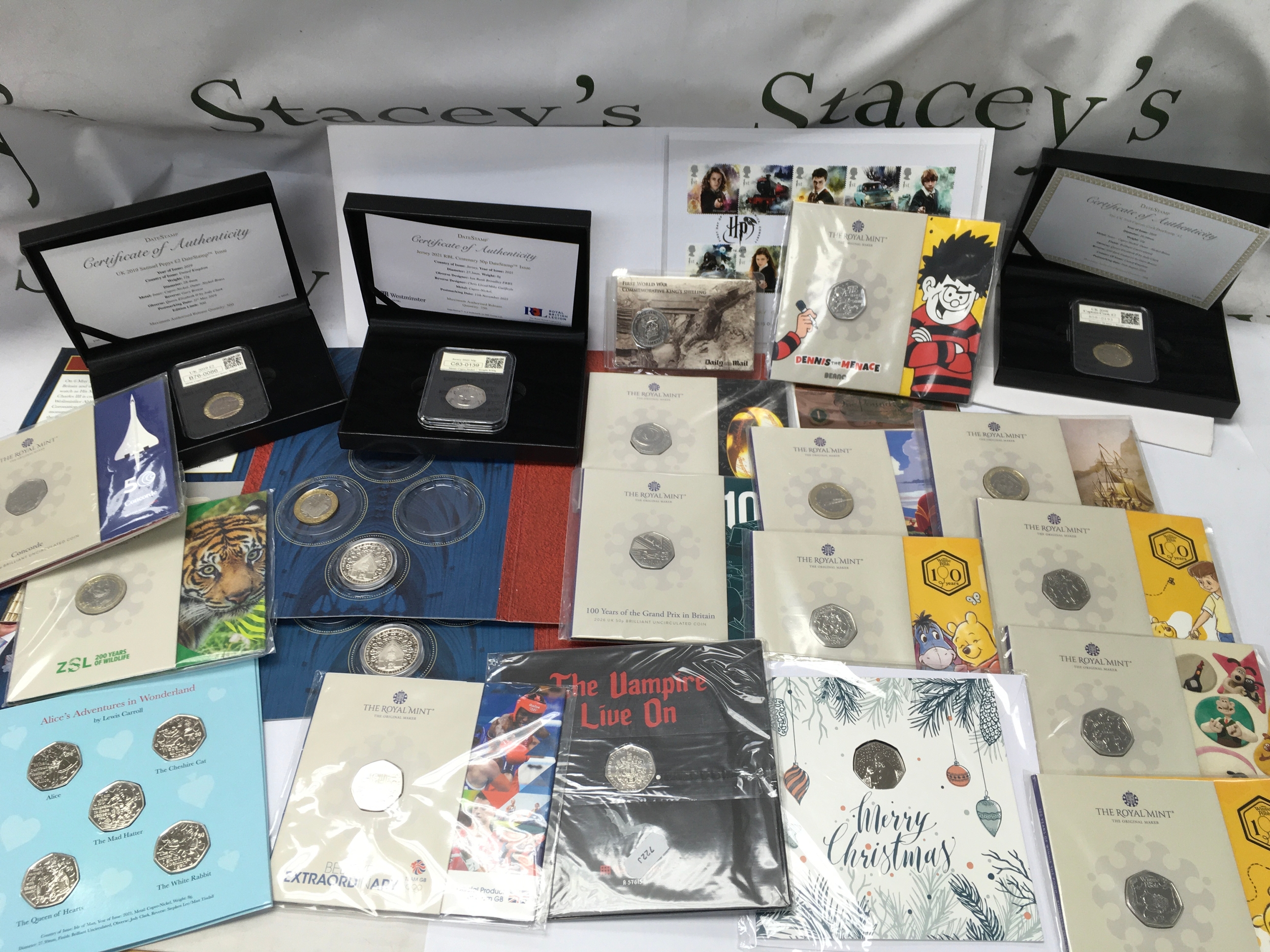 A collection of assorted commemorative 50p and £2 coins including Winnie the pooh, alice in wonderland etc