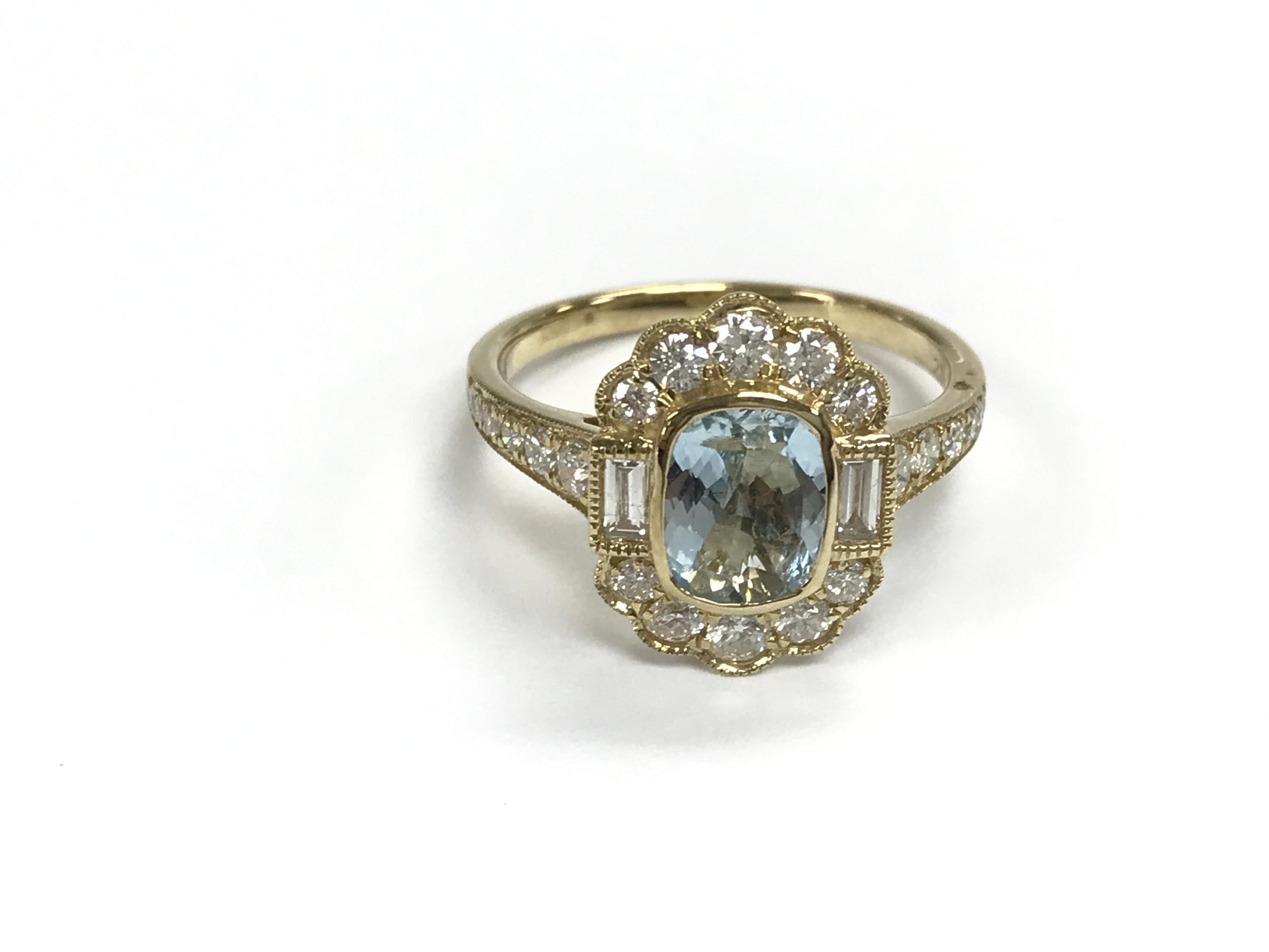 A 9ct gold dress ring set with aquamarine surrounded by diamonds and diamond set shoulders. Size P 1/2