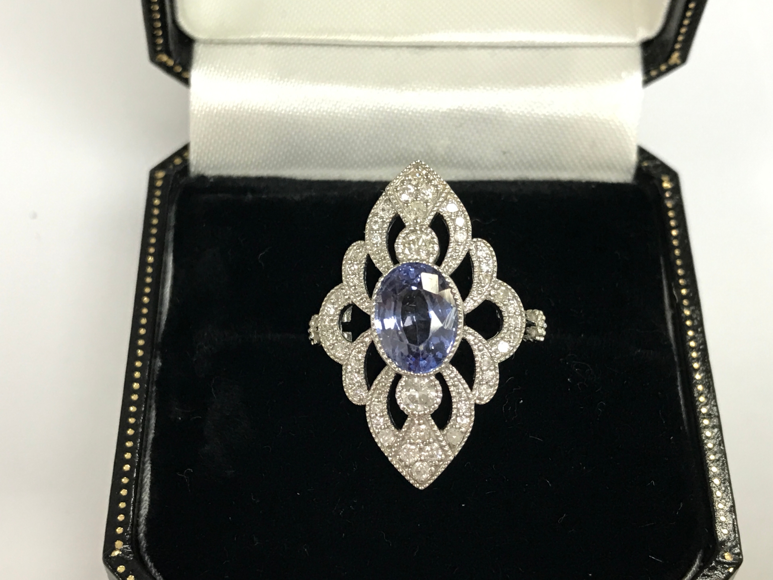 Platinum marquise shaped ring set with oval sapphire and round diamonds. Sapphire 1.74ct and diamonds 0.32ct. Size L 1/2