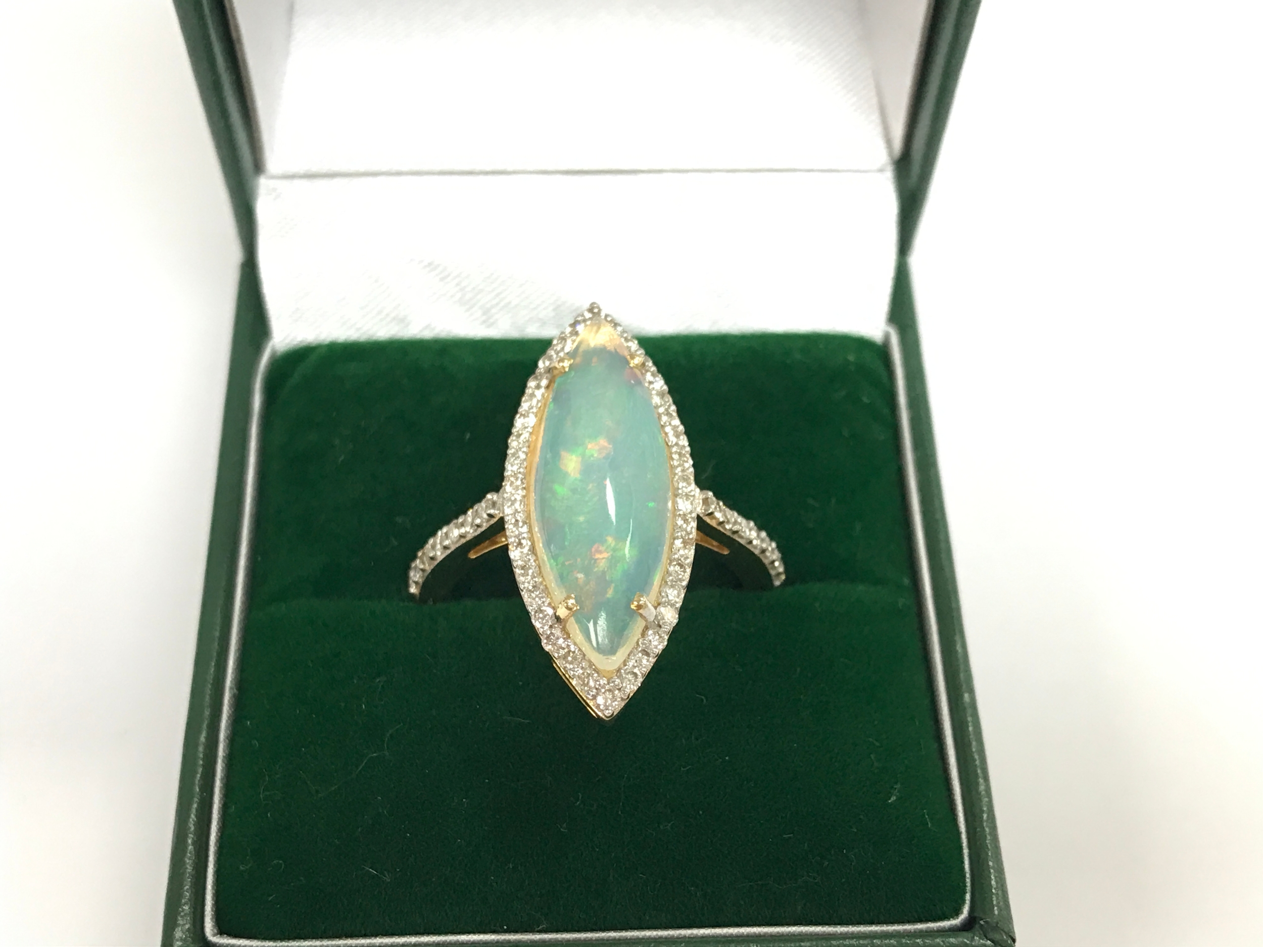 14ct (unmarked) gold marquise shaped ring set with marquise shaped cabochon Opal surrounded by diamonds. 3.10ct Opal and 0.61ct diamonds 