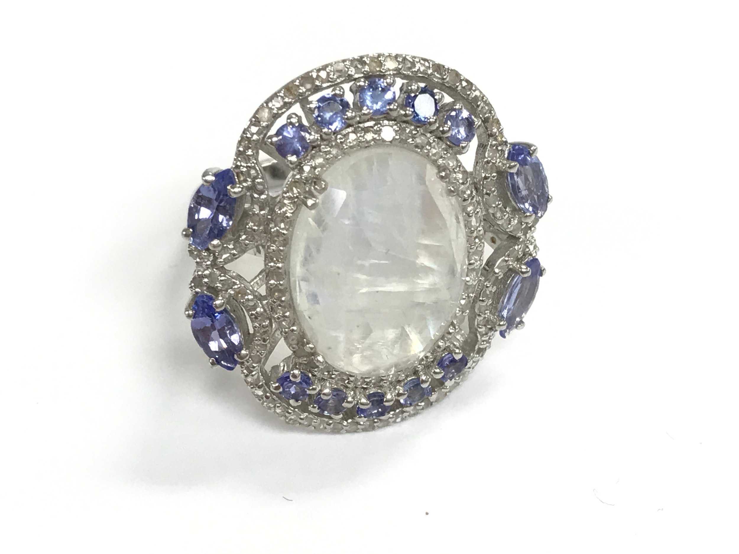 Silver dress ring set with oval moonstone pear and round tanzanite and diamonds. size O