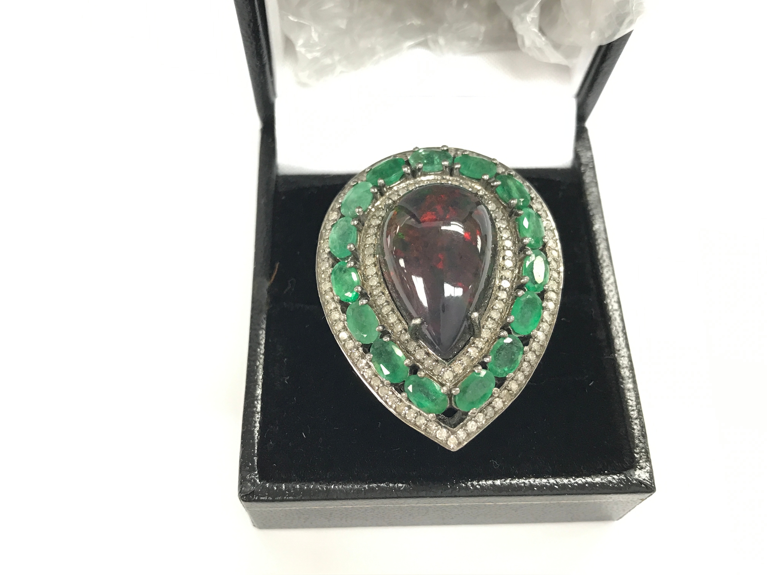 Silver pear shaped dress ring set with pear shaped cabochon black Opal oval emeralds and diamonds. Opal 8.73ct, emerald 3.58ct and diamonds 0.99ct. Size O