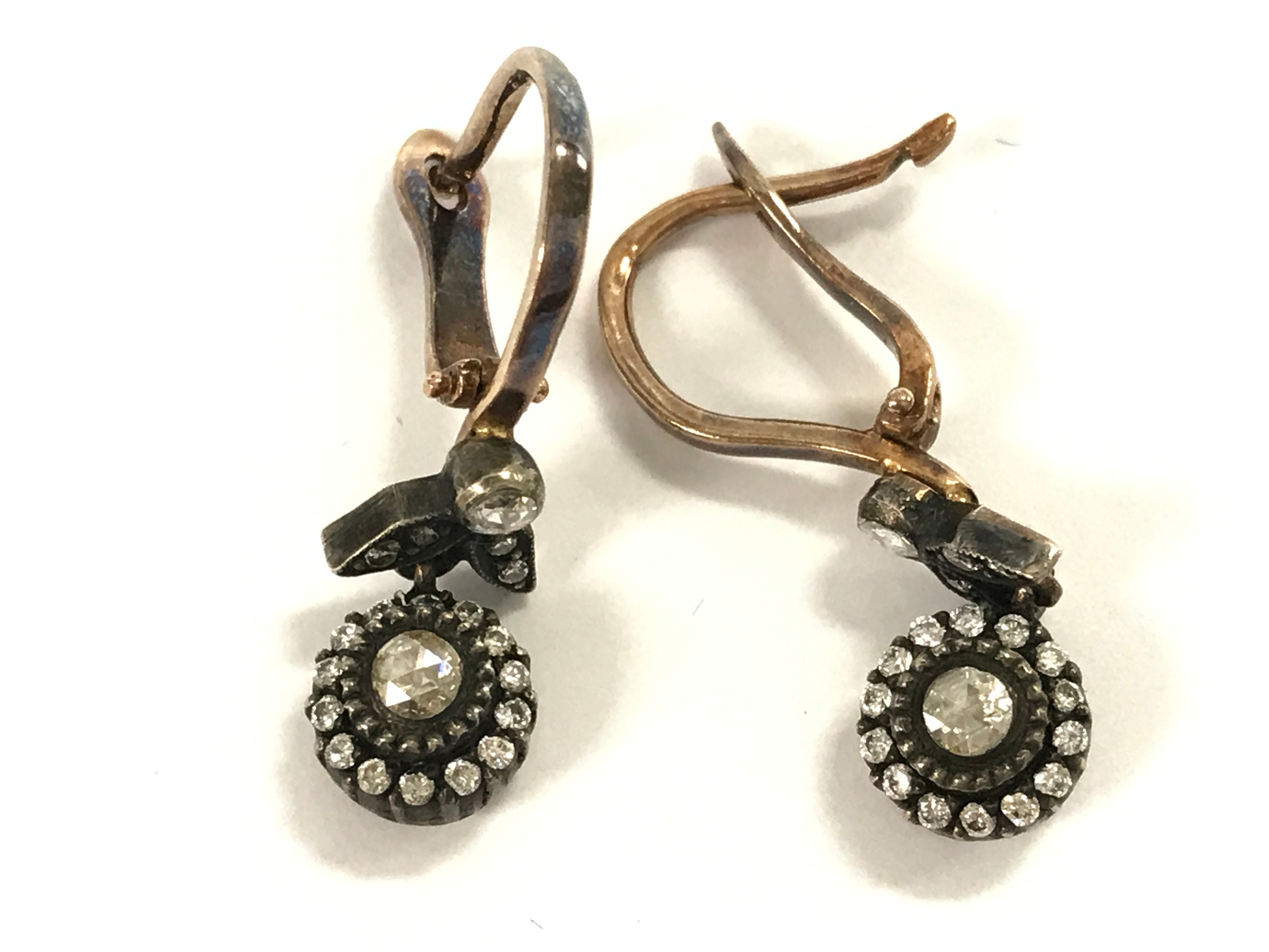 8ct gold and silver (unhallmarked) drop earrings set with rose cut diamonds and round cut with omega fastening.
