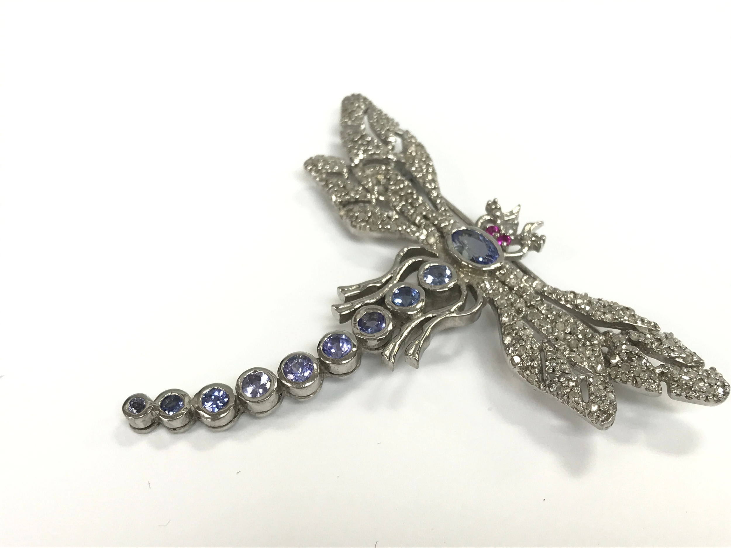 Silver dragonfly brooch/pendant set with tanzanite, rubies and diamonds. Tanzanite 1.38ct, rubies 0.02ct and diamonds 0.92ct approx. 5cm long by 6cm wide