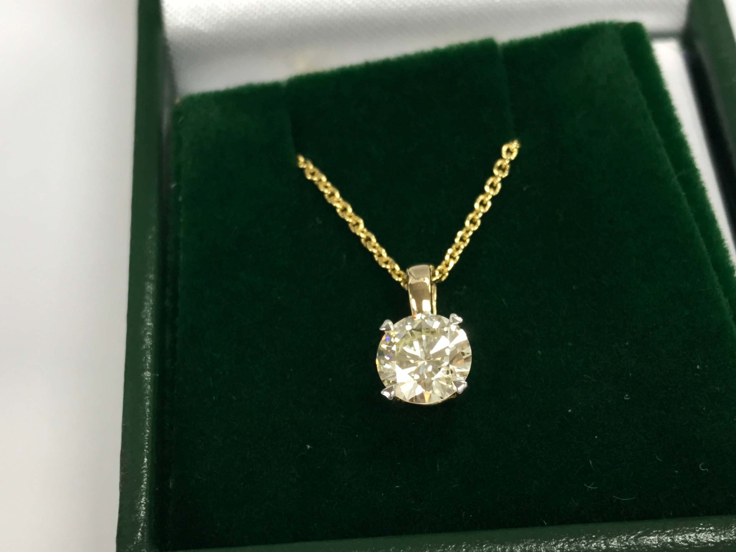 14ct gold round diamond solitaire pendant on a plated silver chain. Diamond 0.76ct