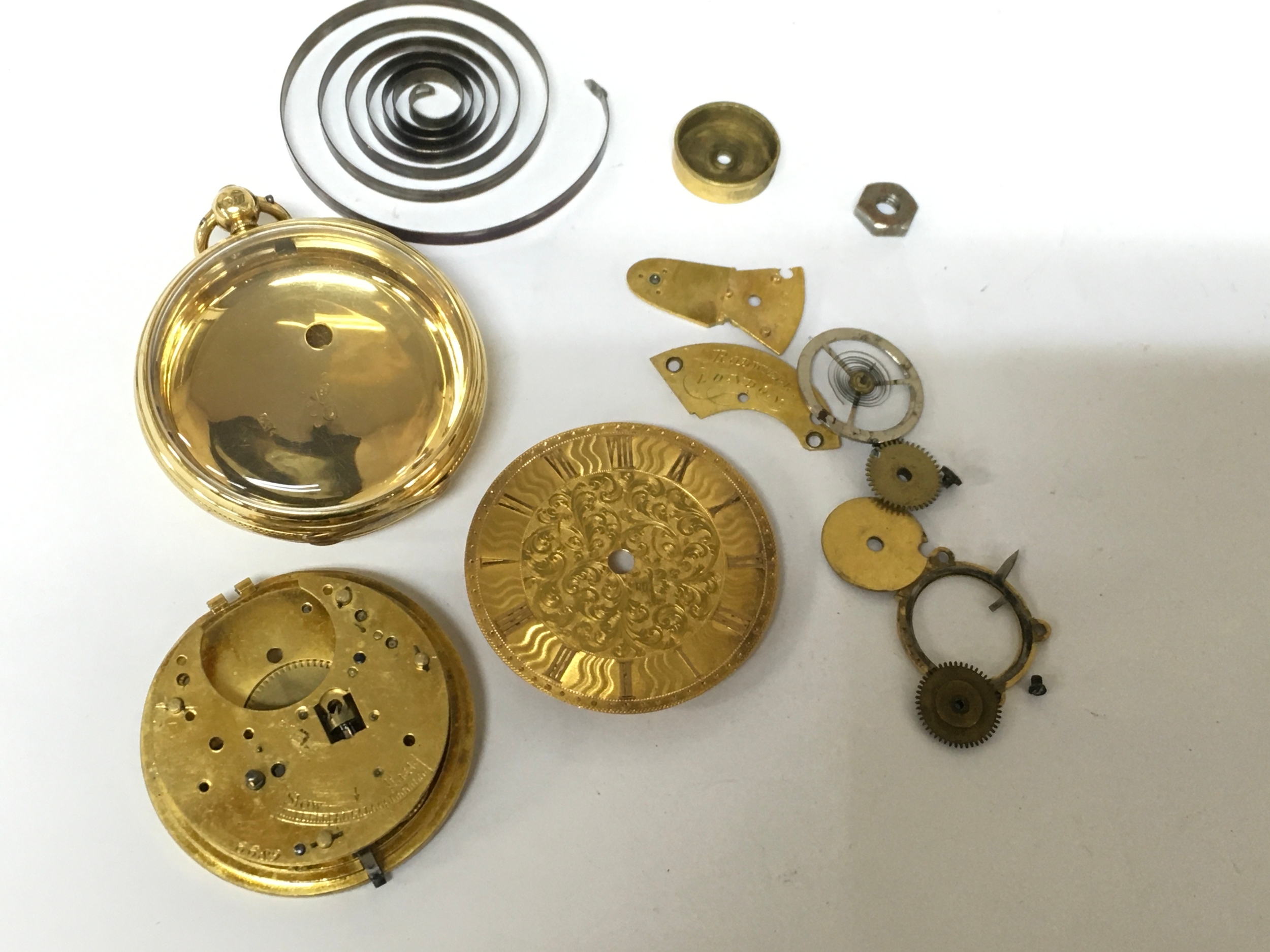 An 18ct gold key wind pocket watch with turned case, offered for spares or repairs. Approx: 4x4cm 14ct 24.7g empty vase weight excluding movement