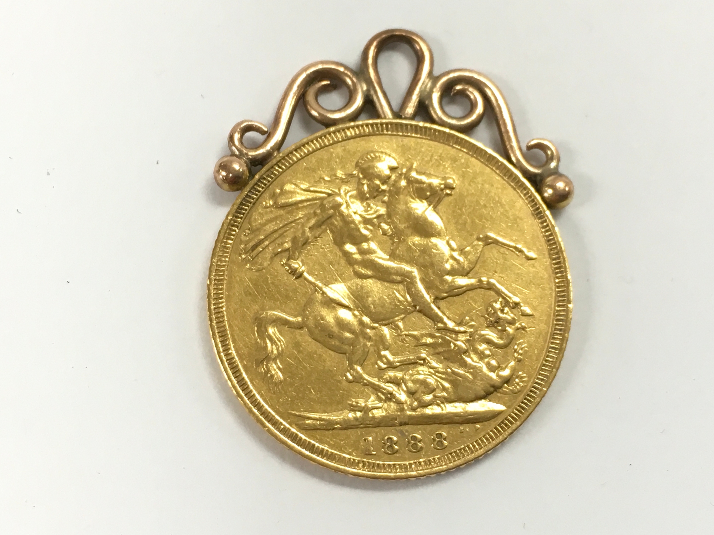 An 1888 Melbourne mint mark sovereign with mount. 8.5g