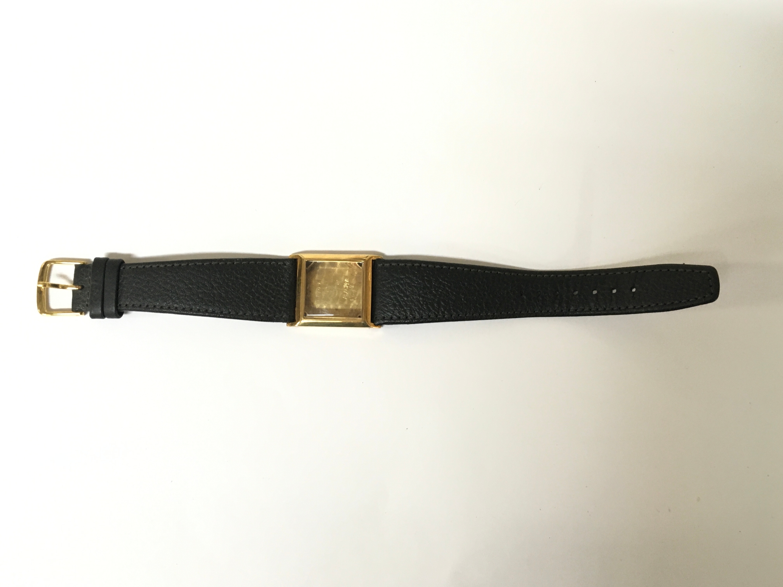 A 14k gold vintage Omega watch case of square shape on leather strap. Approx 2.5 x 2.5cm x L23cm. Offered for spares or repairs, case only. 17.1g