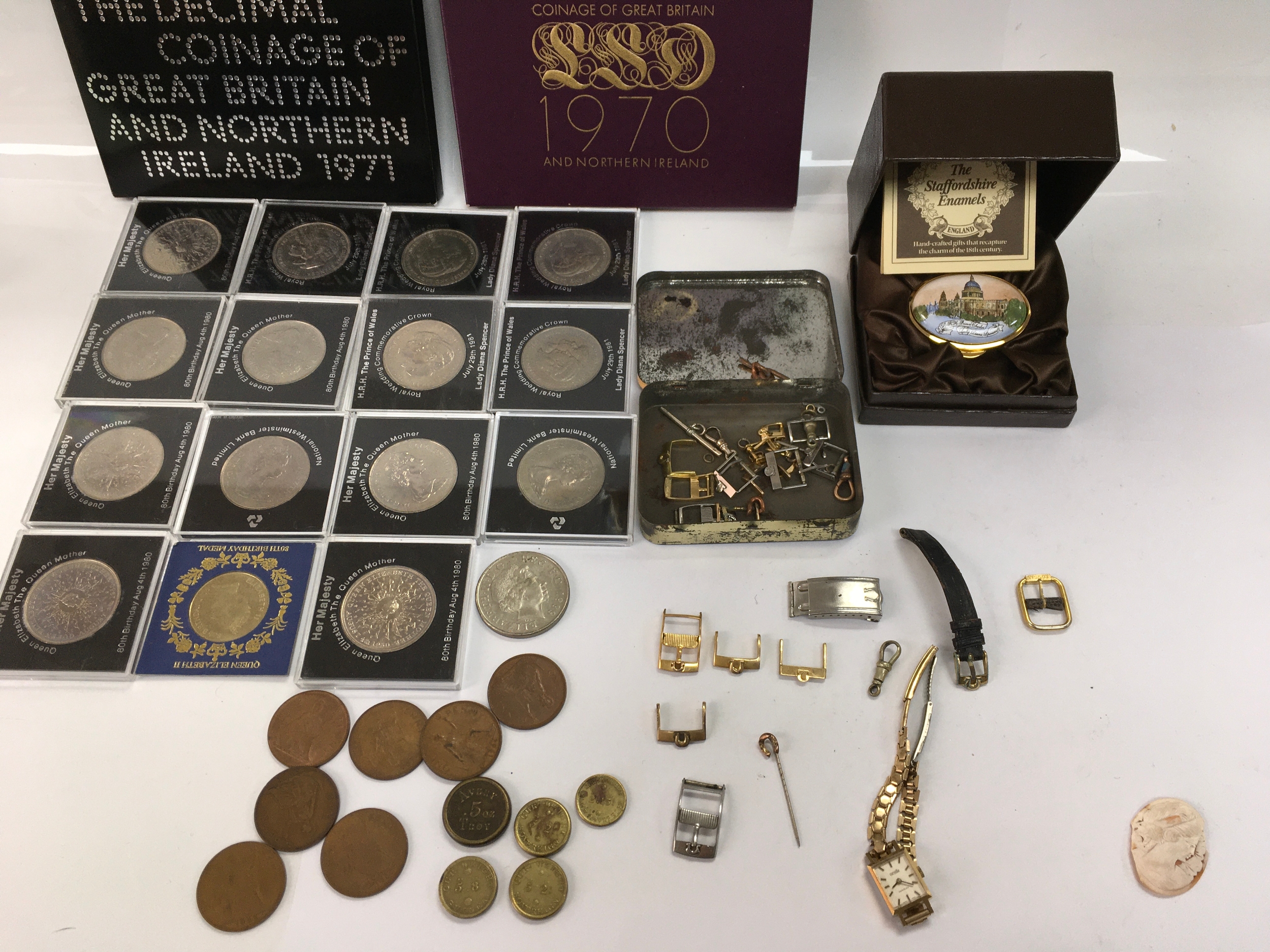 Commemorative coins 1970 and 1971 coin sets and a collection of various watch buckles etc