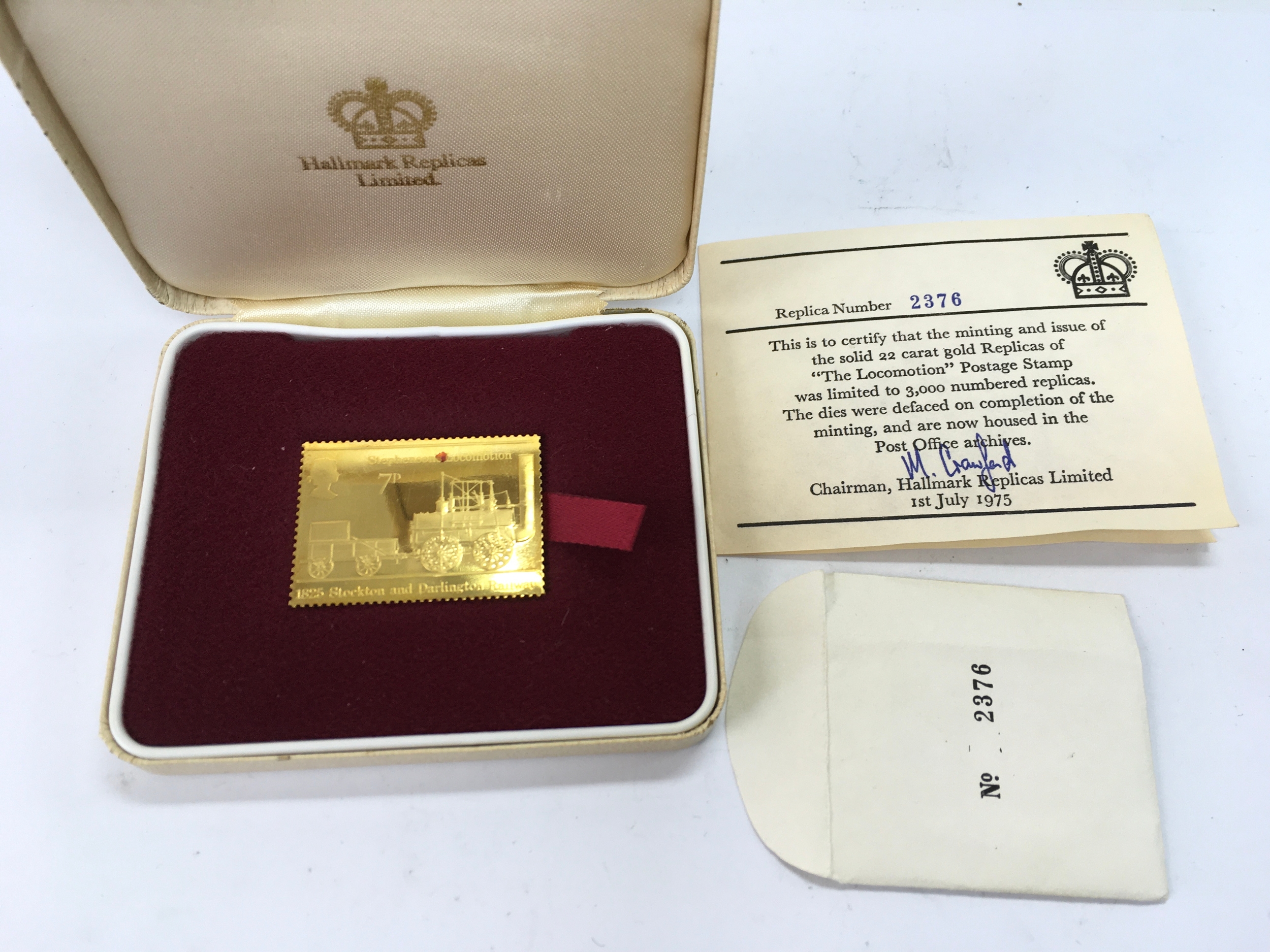 cased 22-carat gold replica of the British 7p "The Locomotion" postage stamp
26.8g
