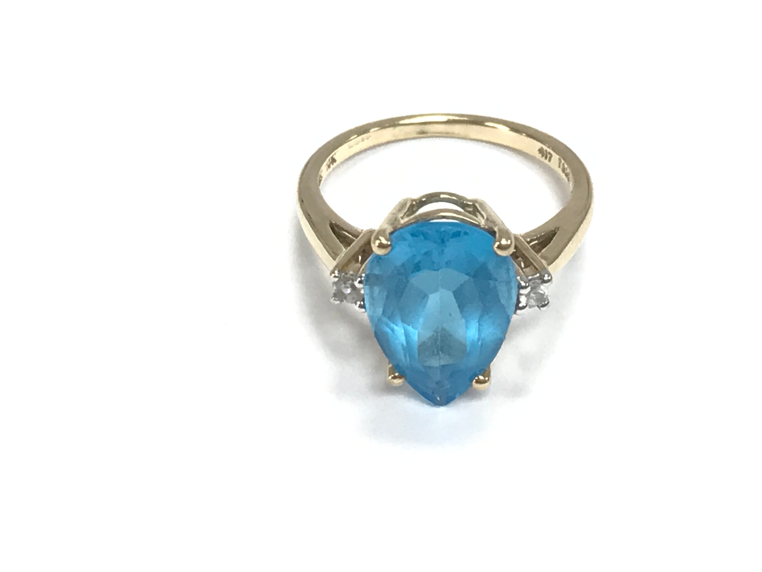 A 9ct gold ring set with pear shaped blue stone. Size L and 3.2g
