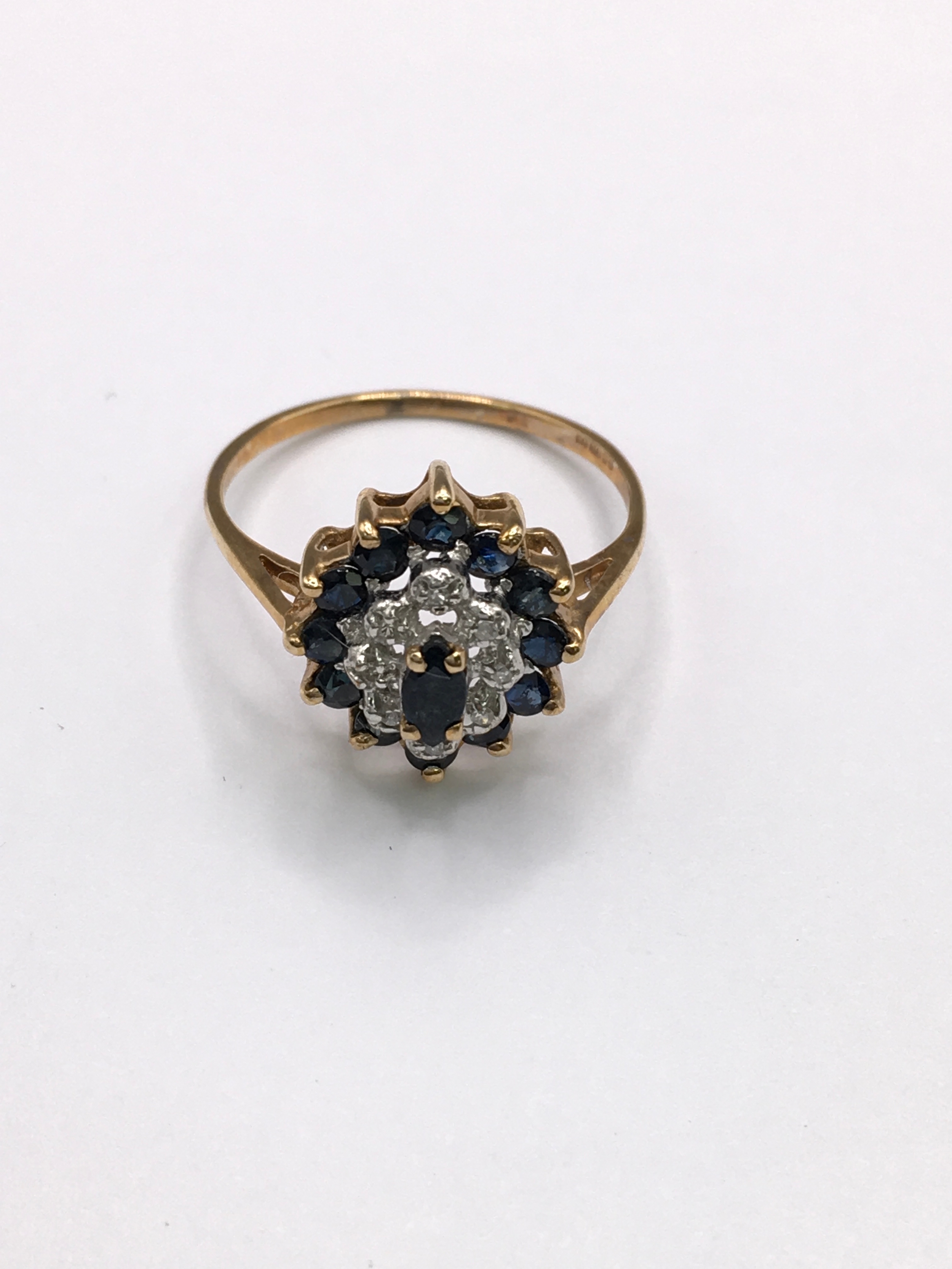 A 9ct gold cluster ring set with small sapphires and diamonds. Approx size P/Q
