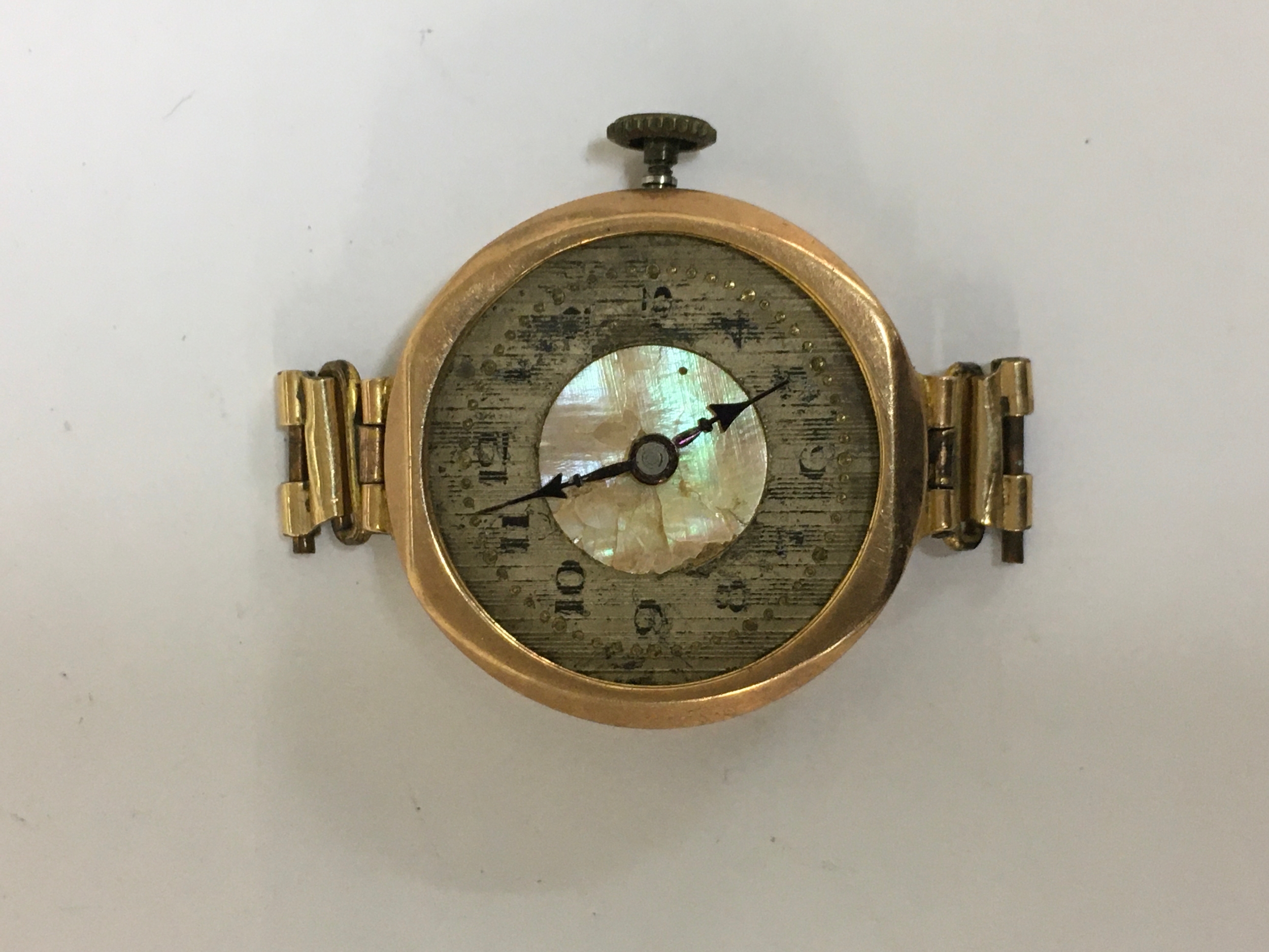 A 9ct gold antique watch face, offered as spares or repairs. Approx: 2x2cm 12.8g