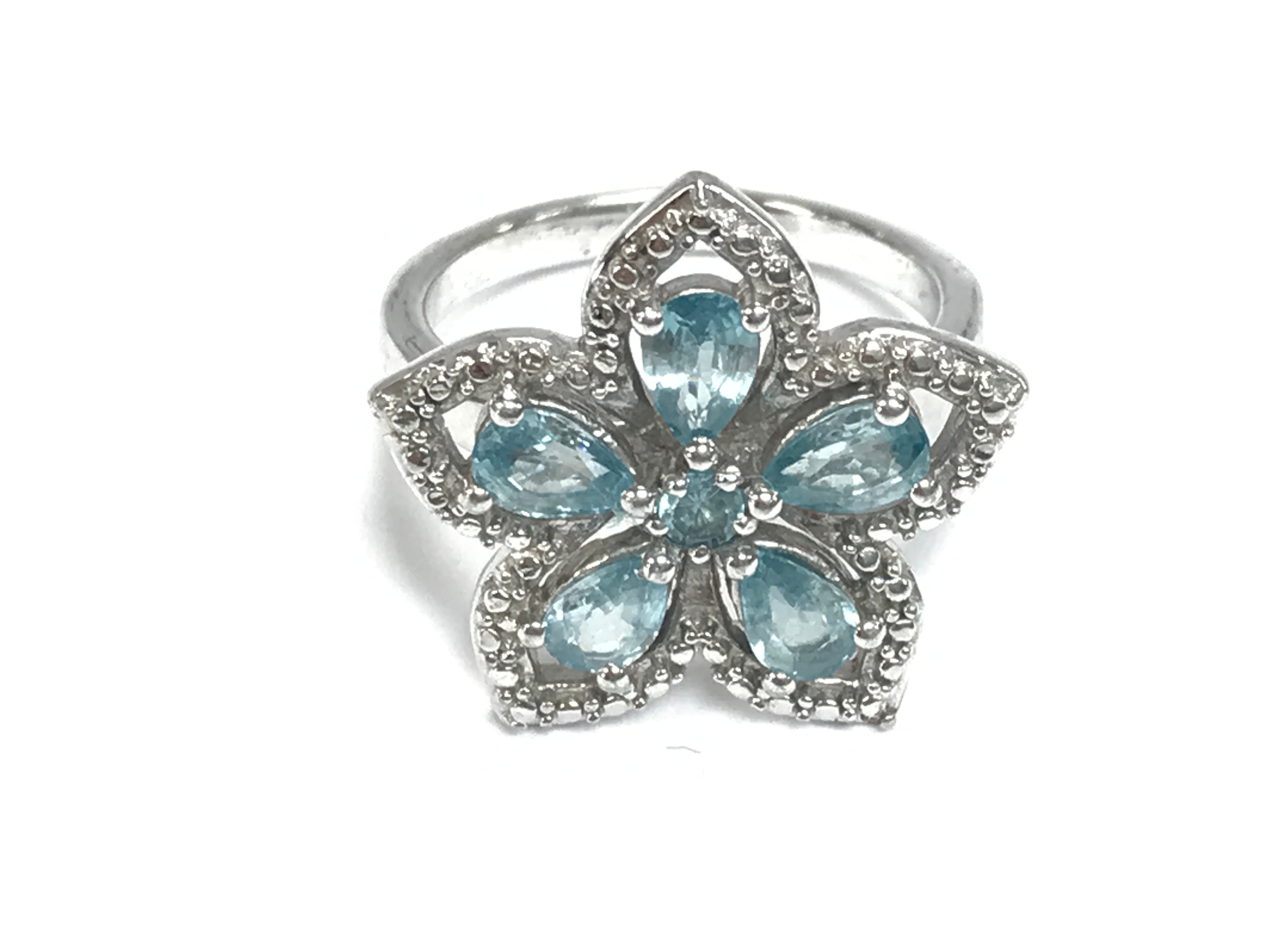 Gold plated silver floral-cluster ring set with blue and white zircon stones. Size R 1/2