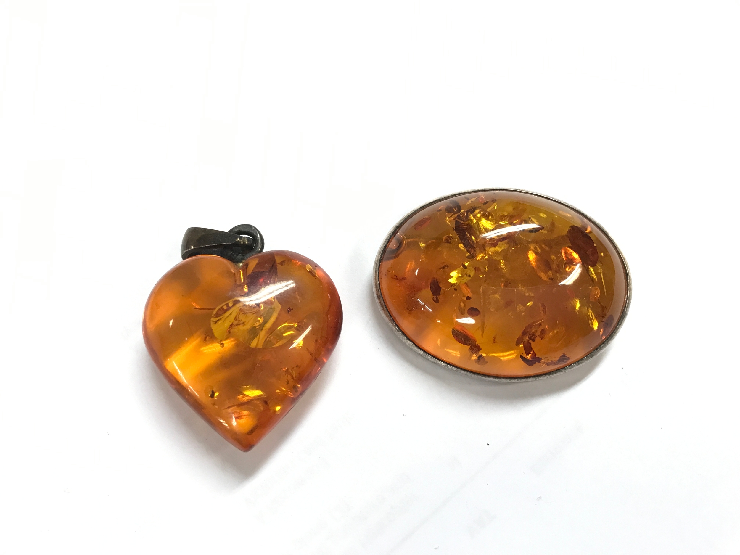 Two amber pieces, a pendant and brooch 