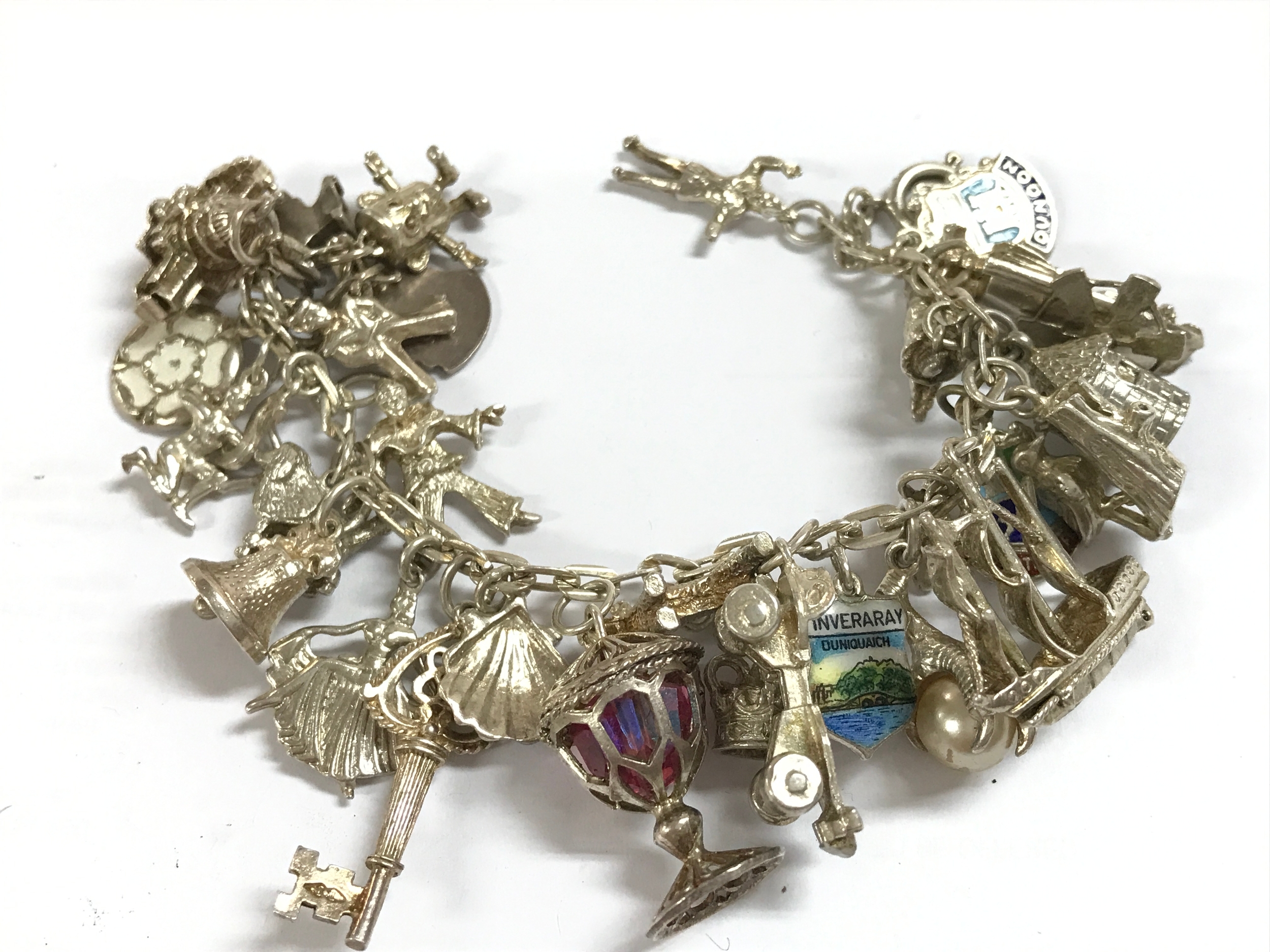 A silver charm bracelet, 66 grams