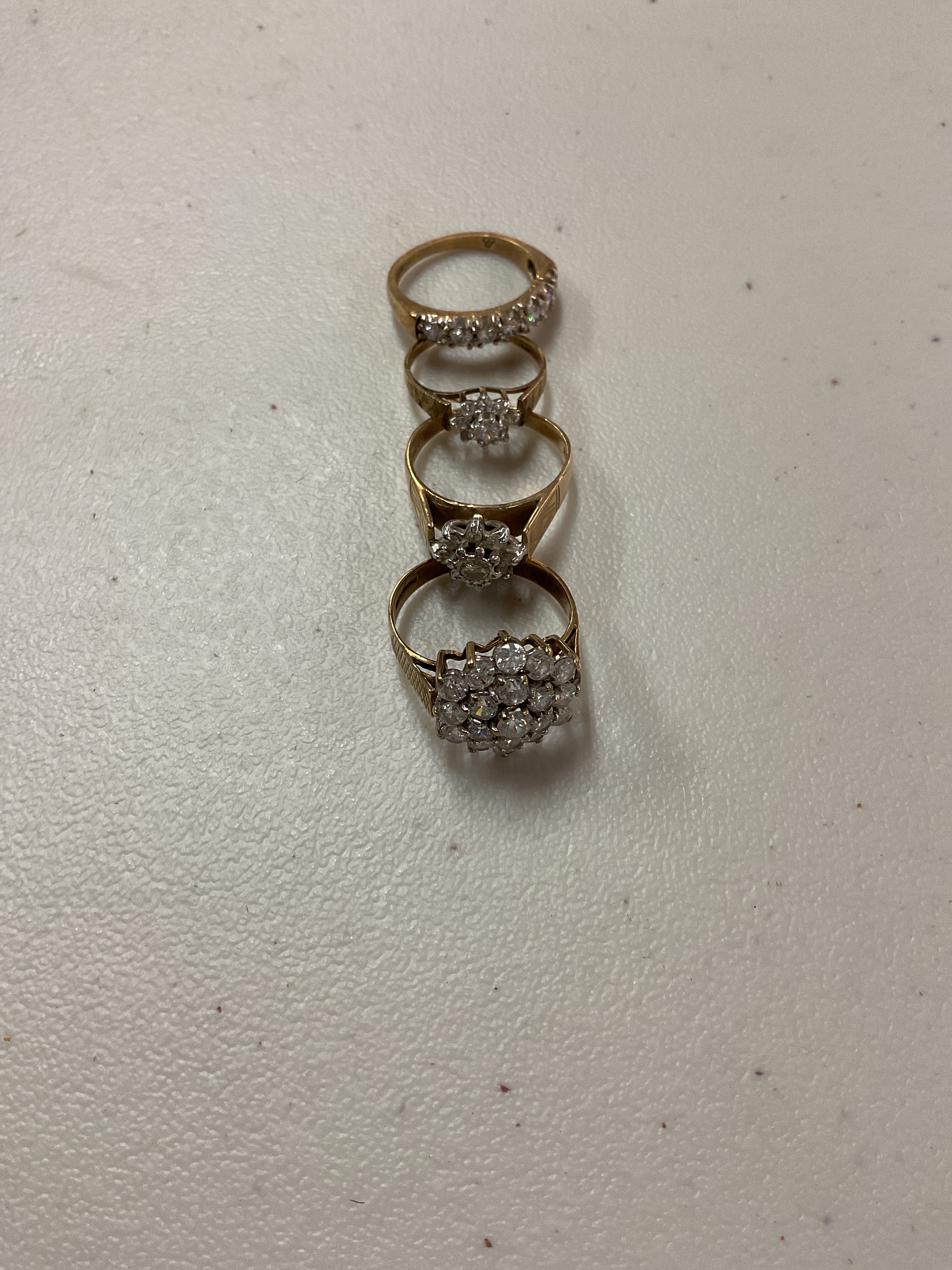 Four 9 ct CZ dress rings weight 12 grams.
