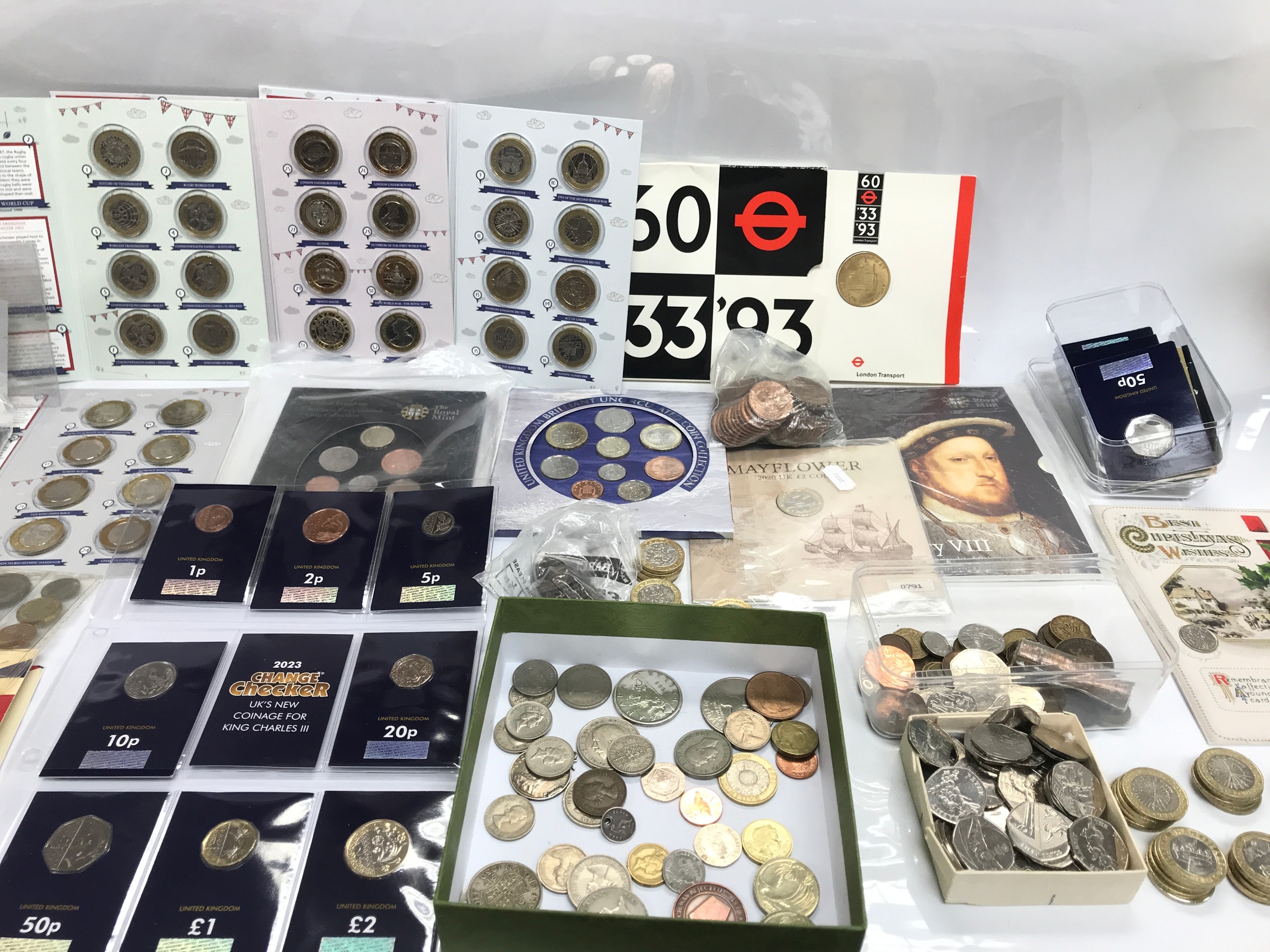 A collection of coin sets and change checker coins including Olympic 50p coins etc
