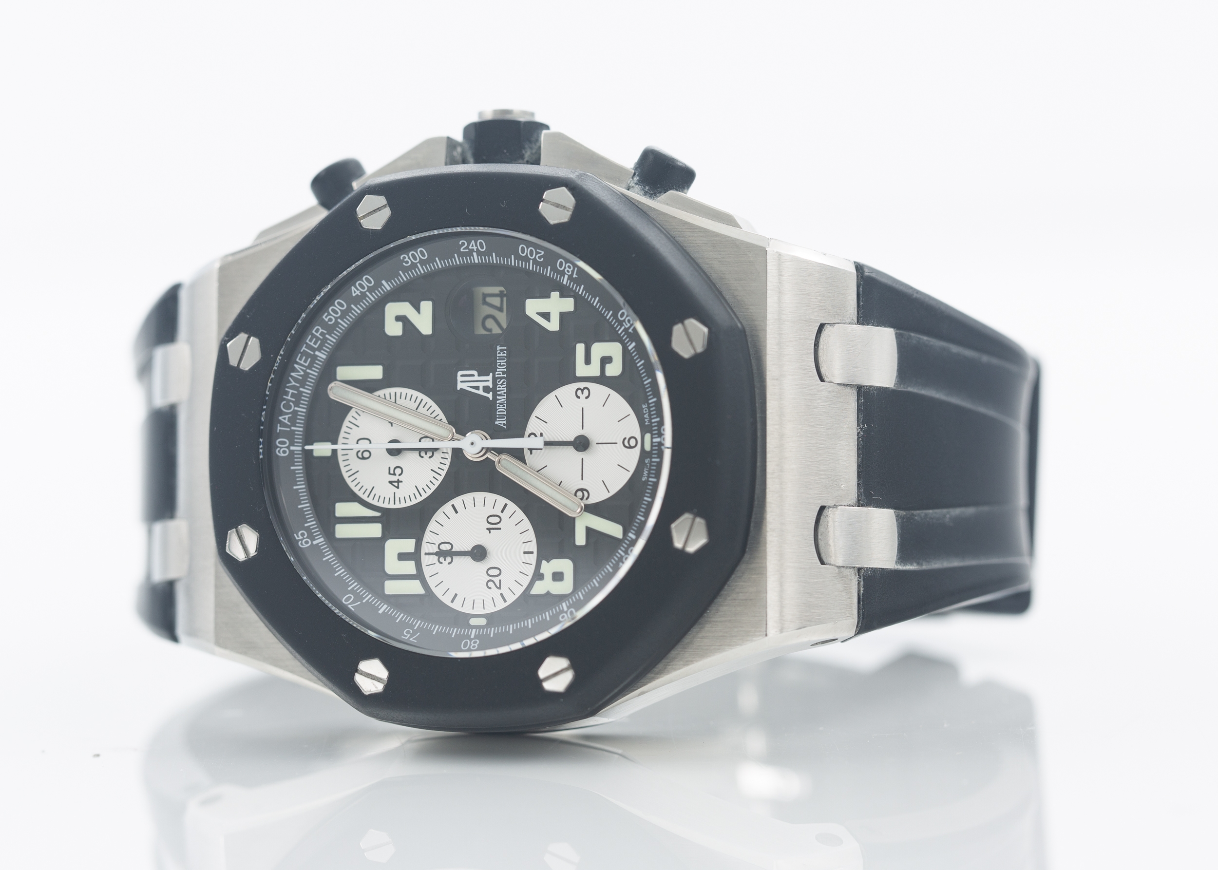Audemars Piguet Royal Oak Offshore Chronograph. Stainless steel measuring 42 mm across. Black textured face with white sub-dials and bold Arabic numbers. Box and Manual. Wind and runs.