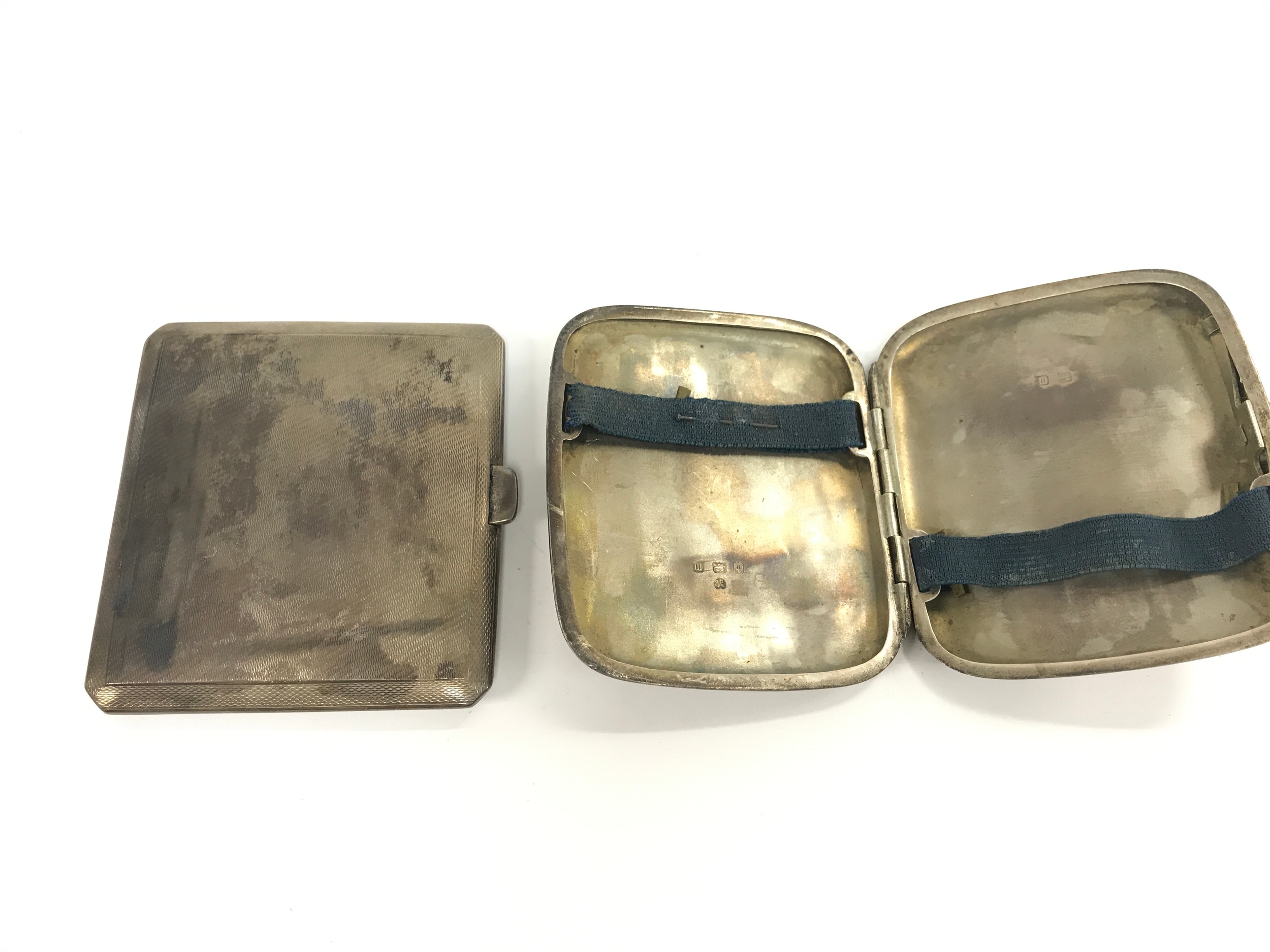 Two silver cigarette cases.