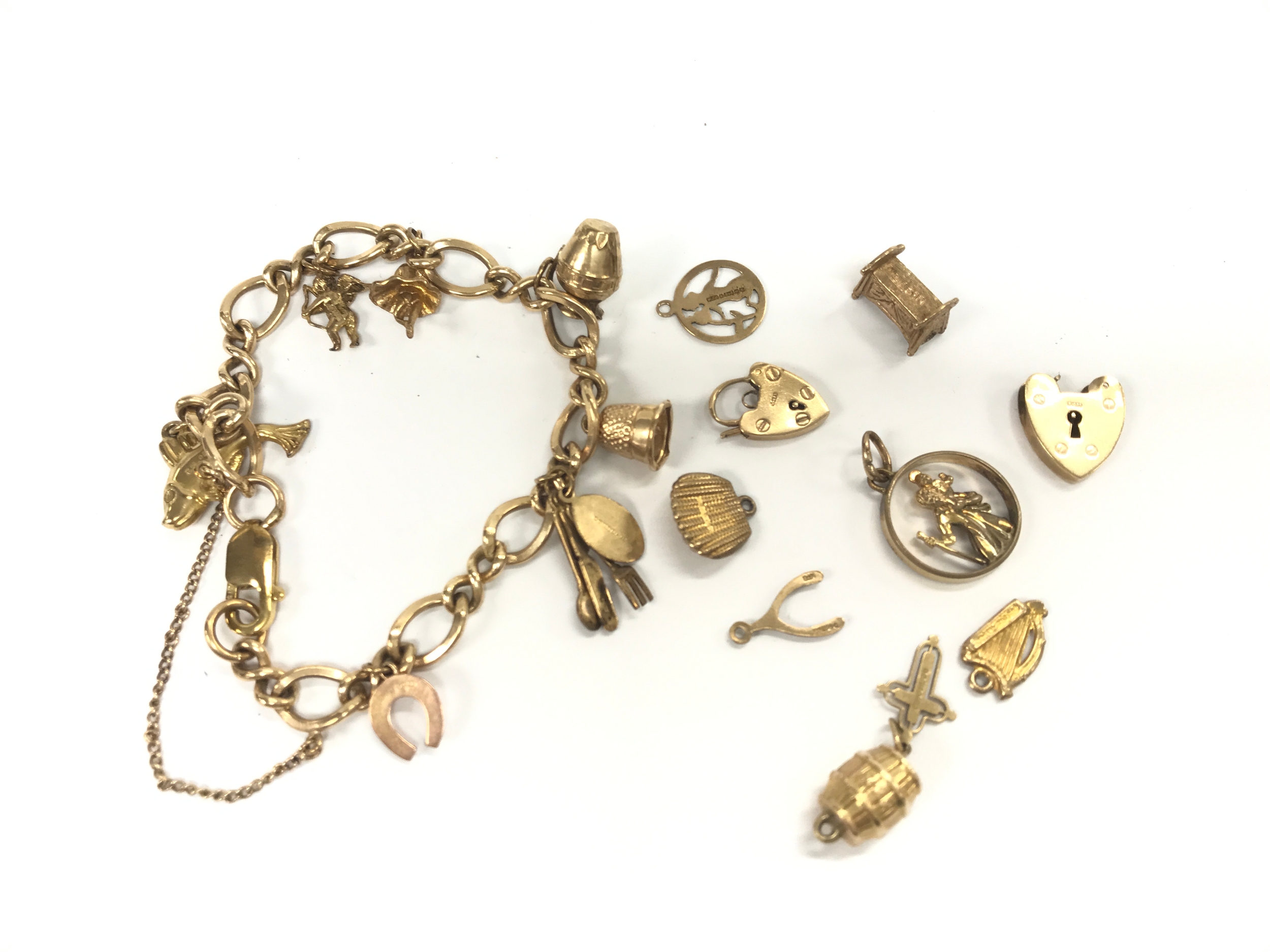9ct charm bracelet with assorted other charms and pendants.
31.6g