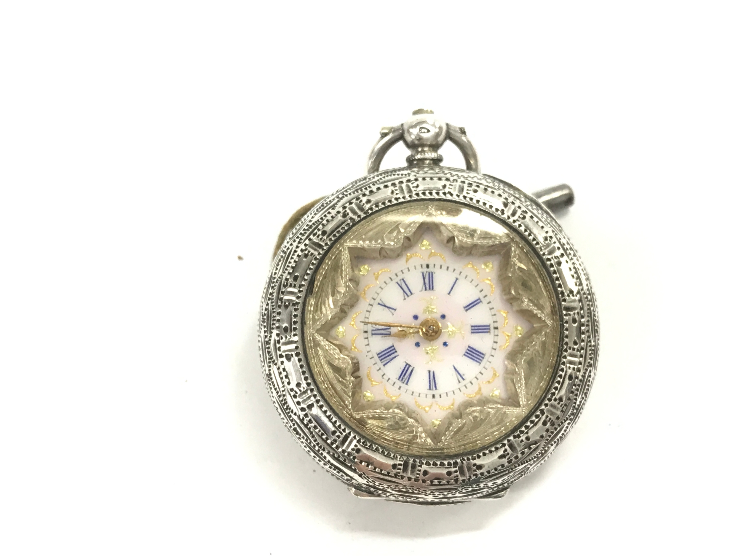 open-face pocket with an ornate silver case and a decorative star shaped inner bezel framing the face. winds and runs.