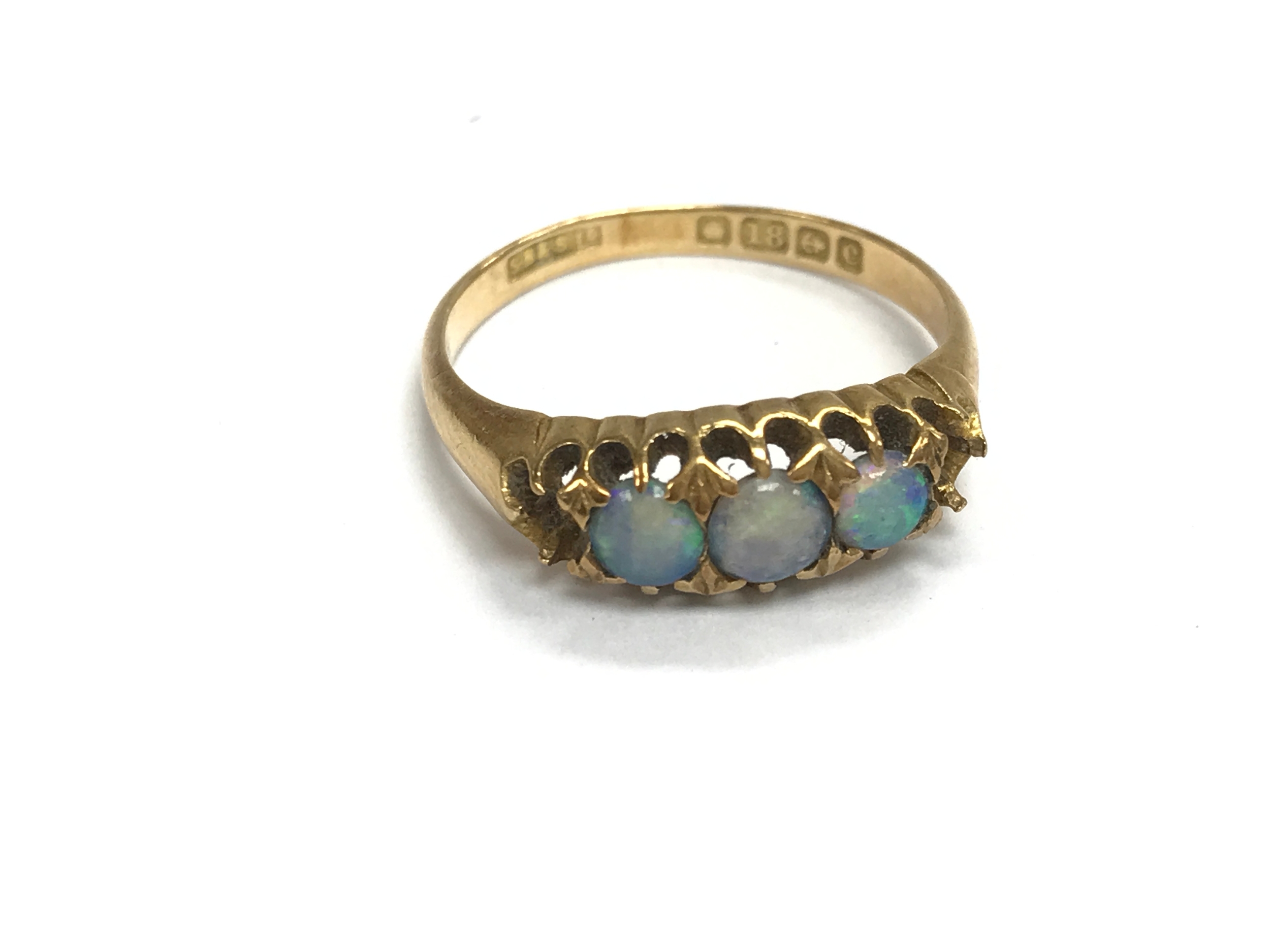 An 18ct gold ring set with opals (two stones missing). p 1/2 and 3.5g
