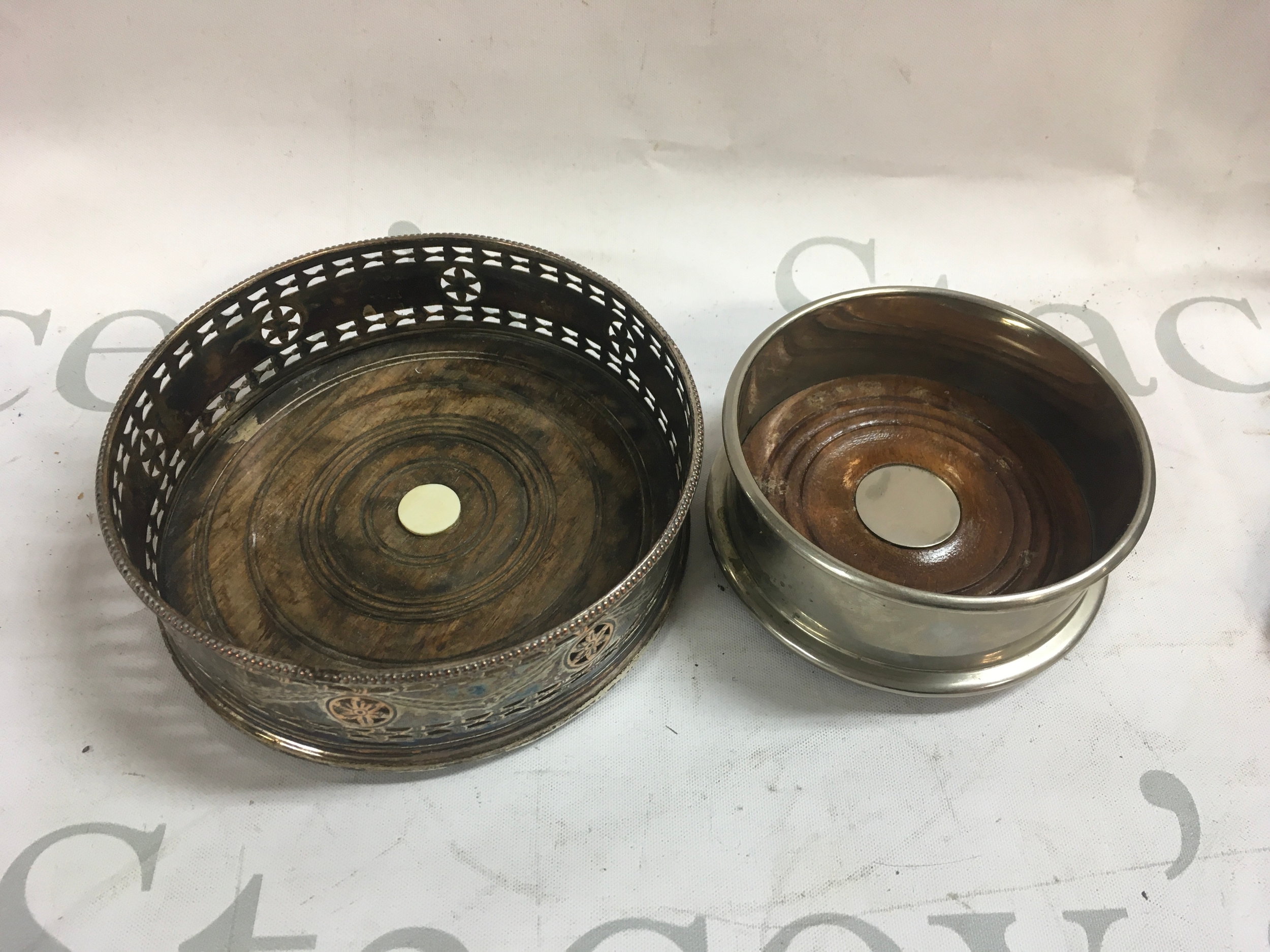 A pair of silver plated wine coasters 