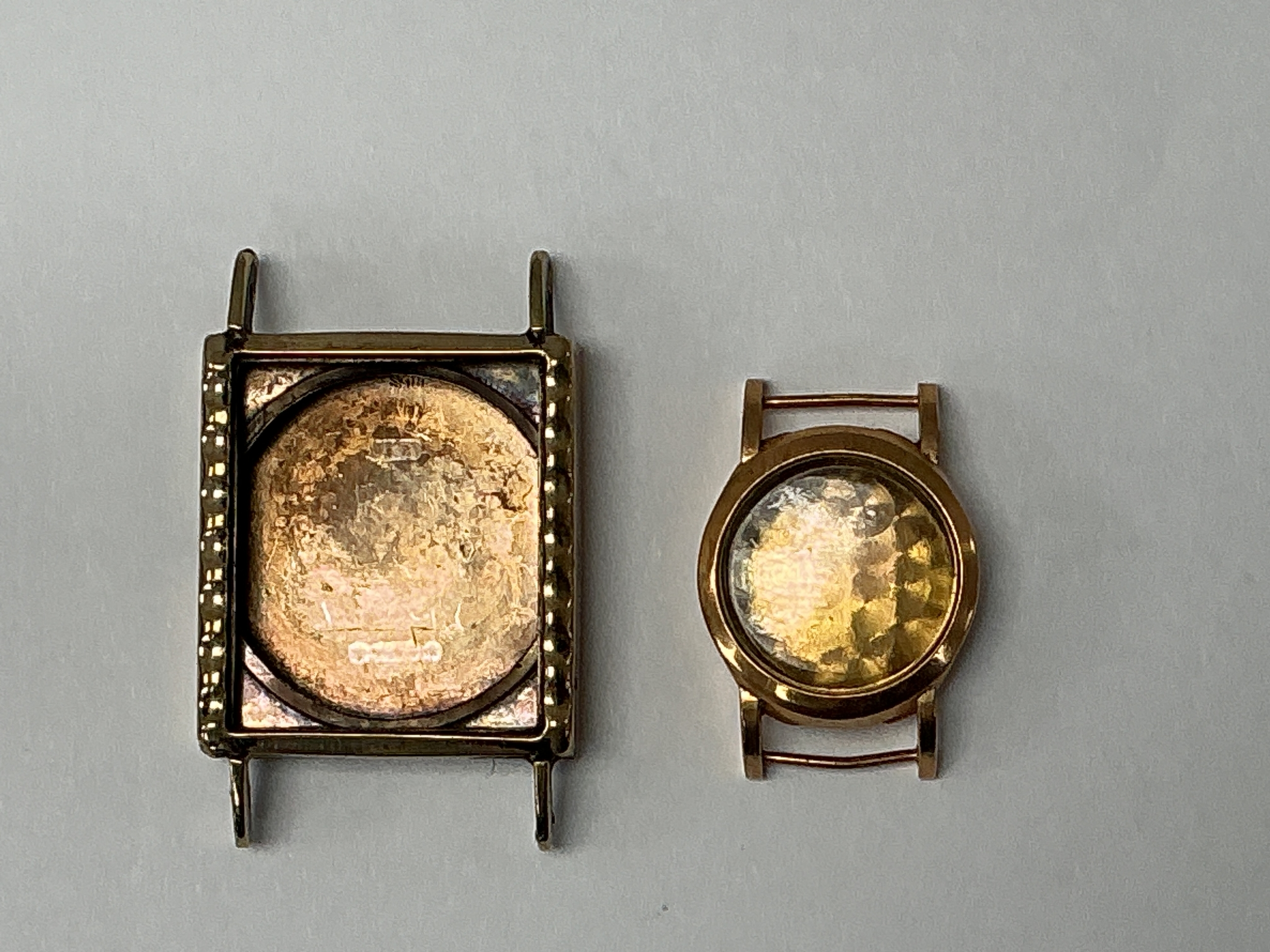 Two gold, empty watch cases, hallmarked 18k and 9ct respectively. 6.92g