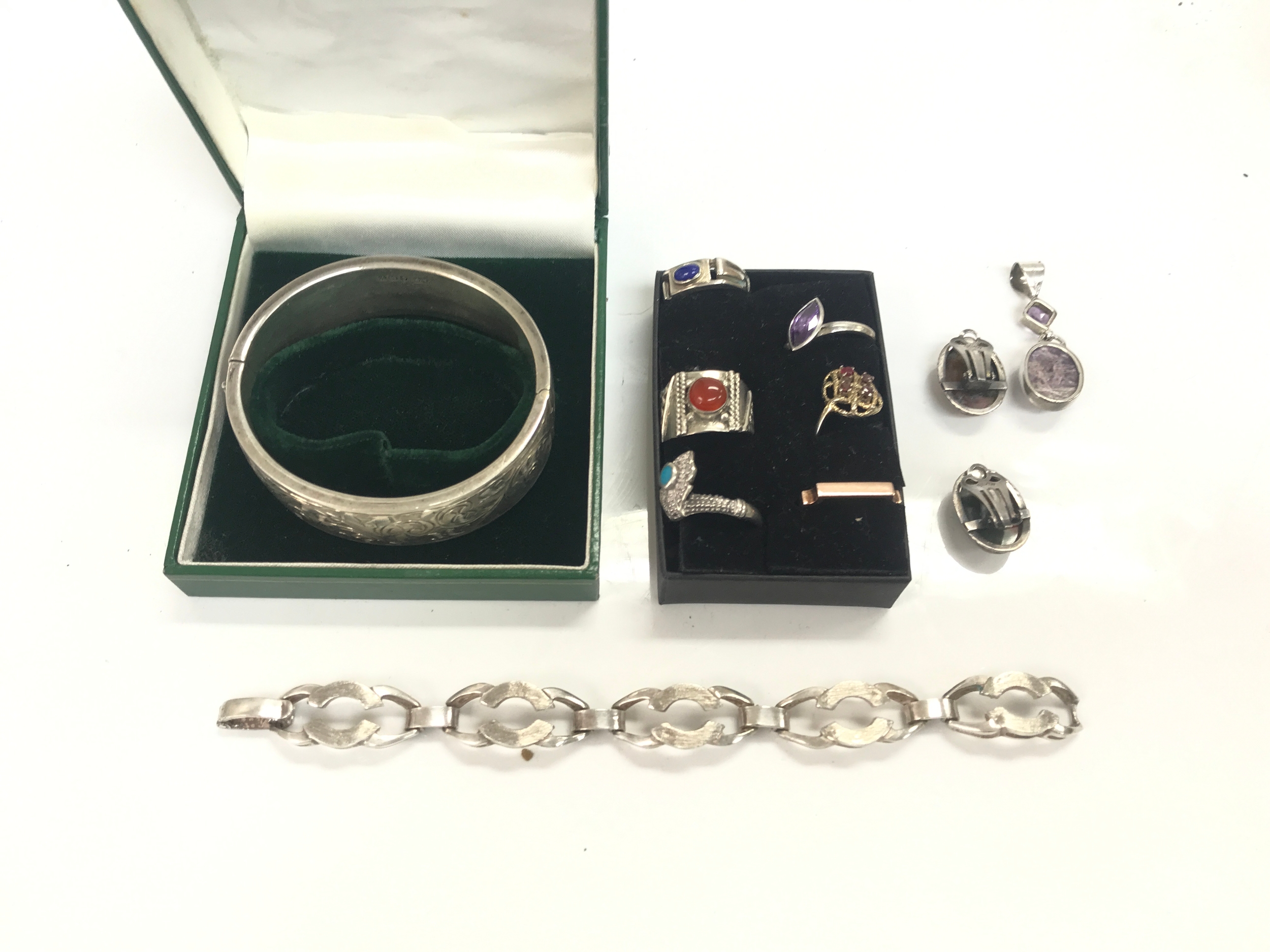 Two silver bracelets (58g) and small amount of silver rings 