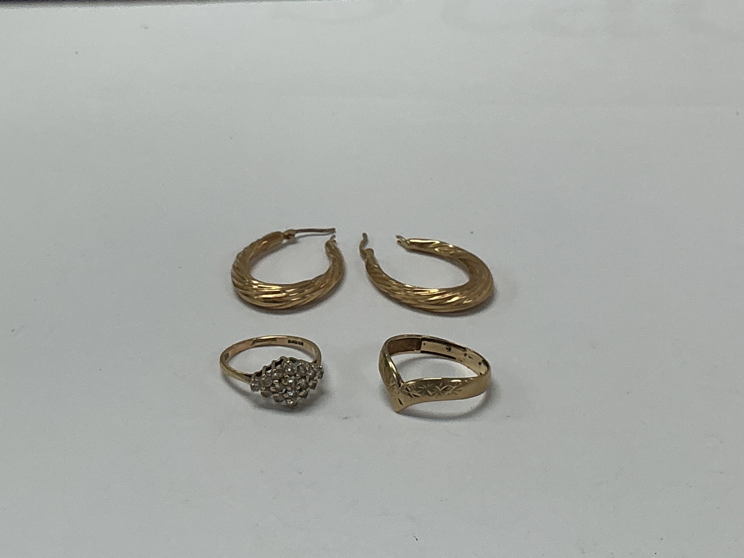 Two 9ct gold rings, one set with white chip stones, plus a pair of 9ct gold hollow hoop earnings. Rings sizes M and R respectively 6.27g