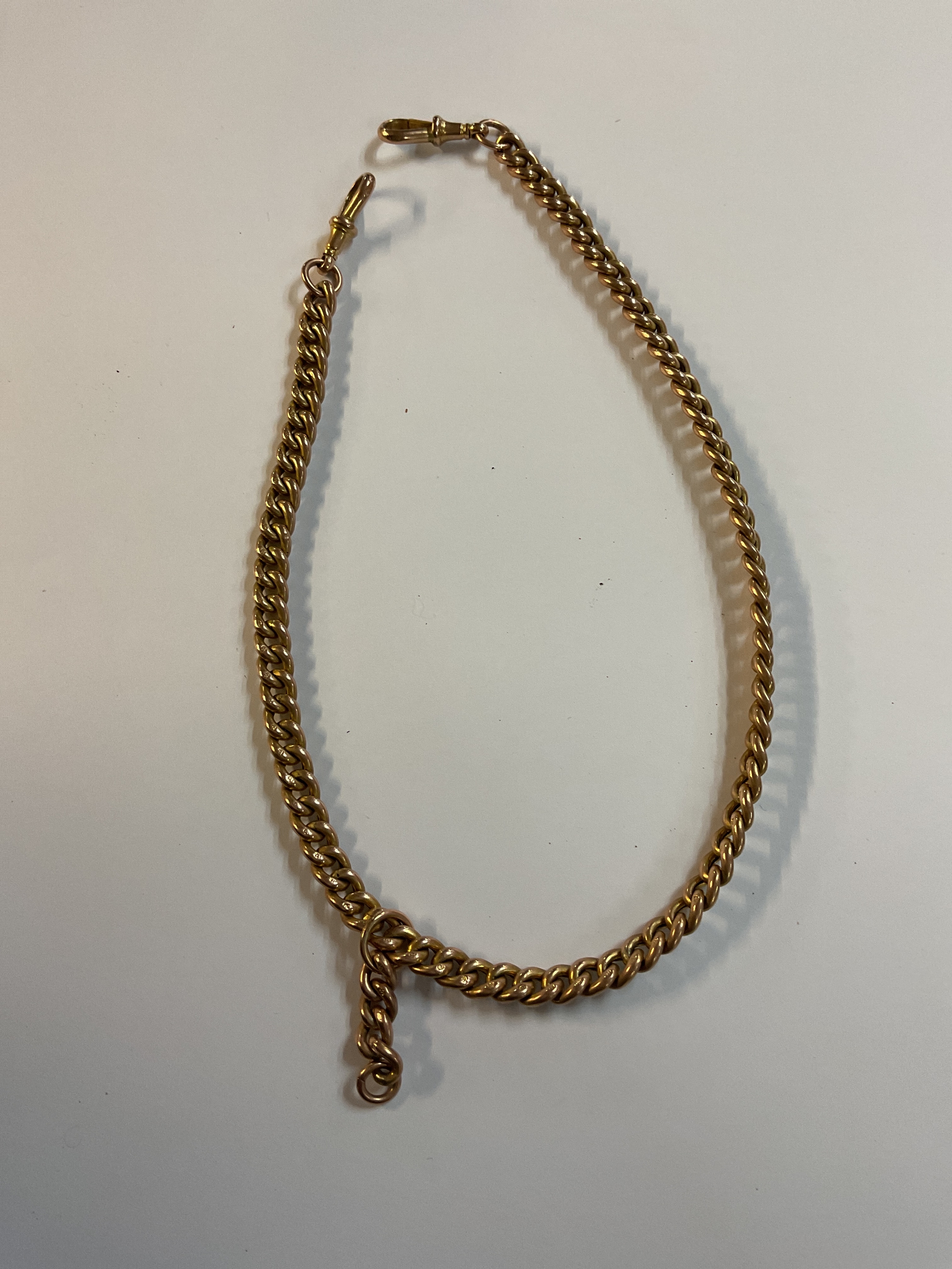 9 ct Albert curb linked watch chain, each link stamped 9, weight 23.4 grams.