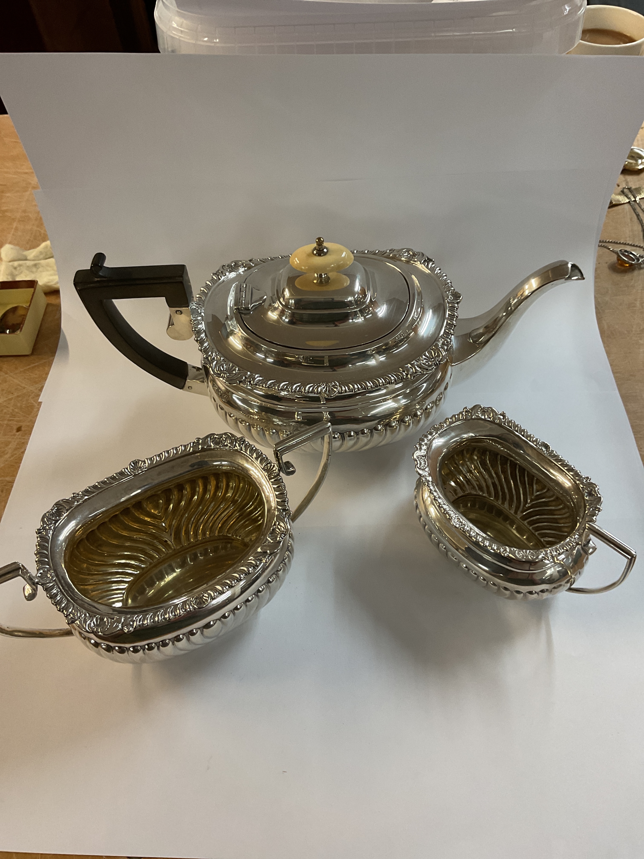 An Edwardian Three piece tea set, maker George Nathan and Ridley Hayes, hallmarked 1904, weight 1057 grams.bone handle finial to the tea pot.