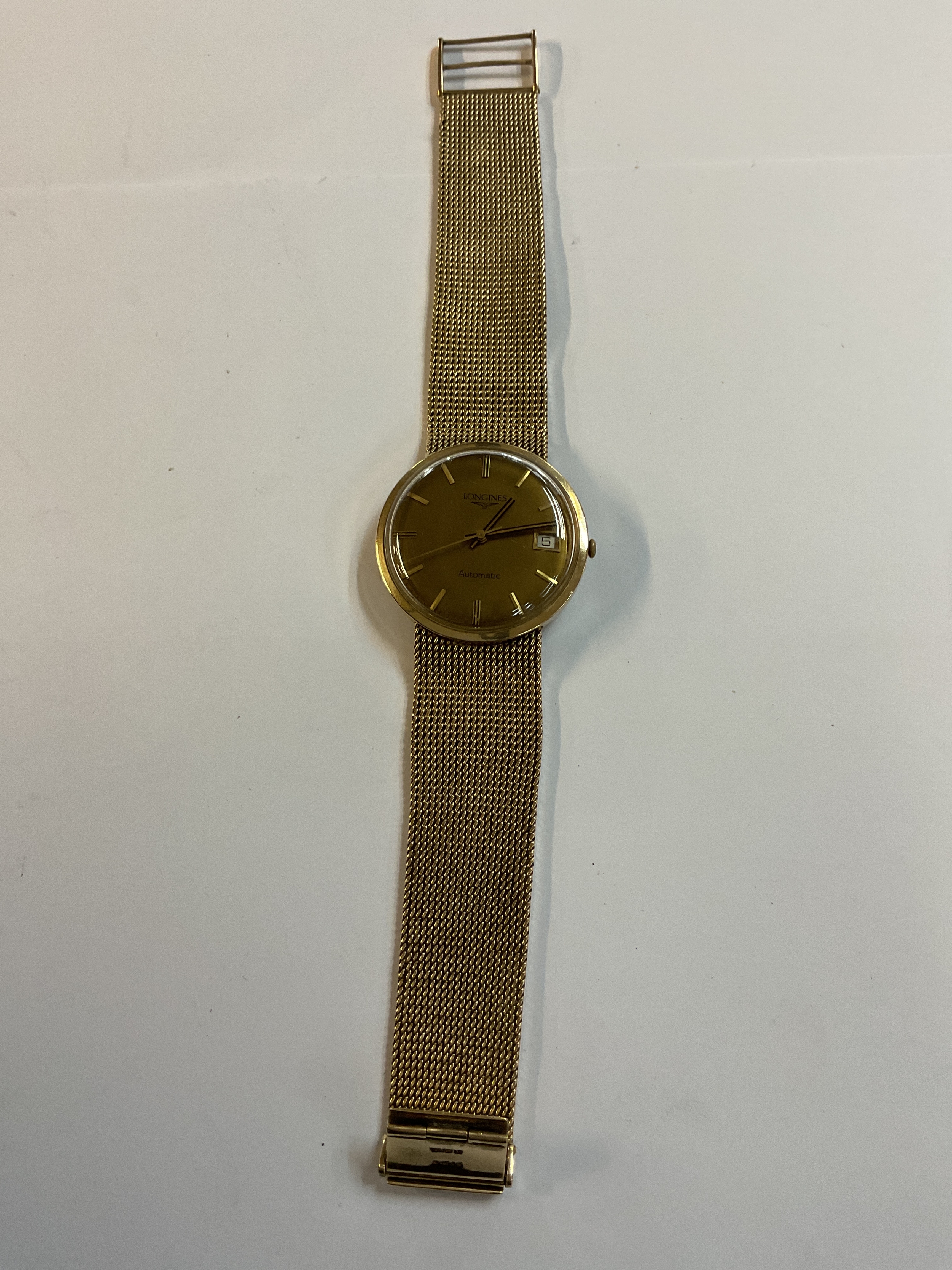 A 9ct gold Longines gents wristwatch, complete with a 9 ct gold Milanese pattern bracelet, hall marked London 1978.