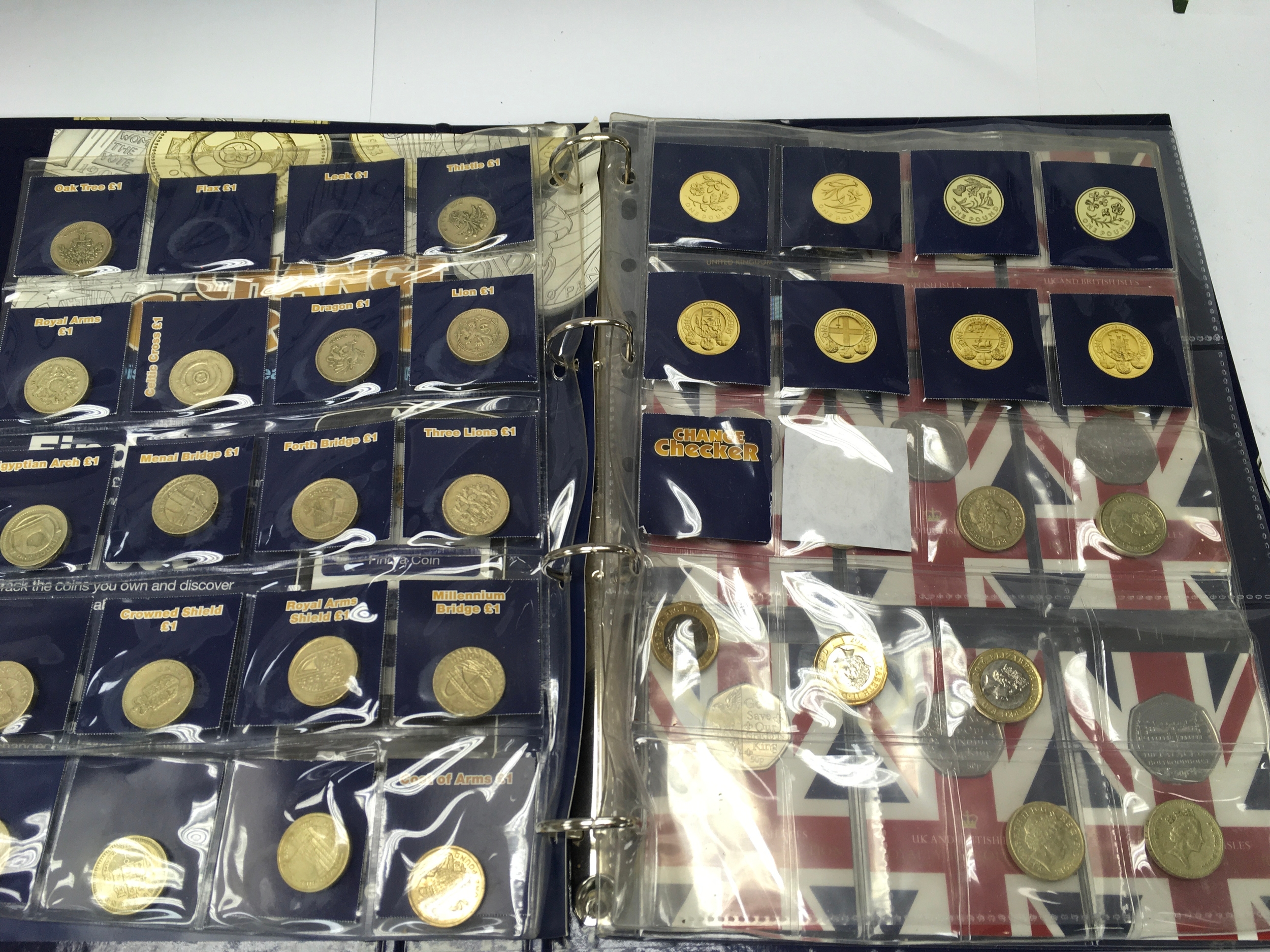 A coin checker album cointaining various £1 coins and 50p's