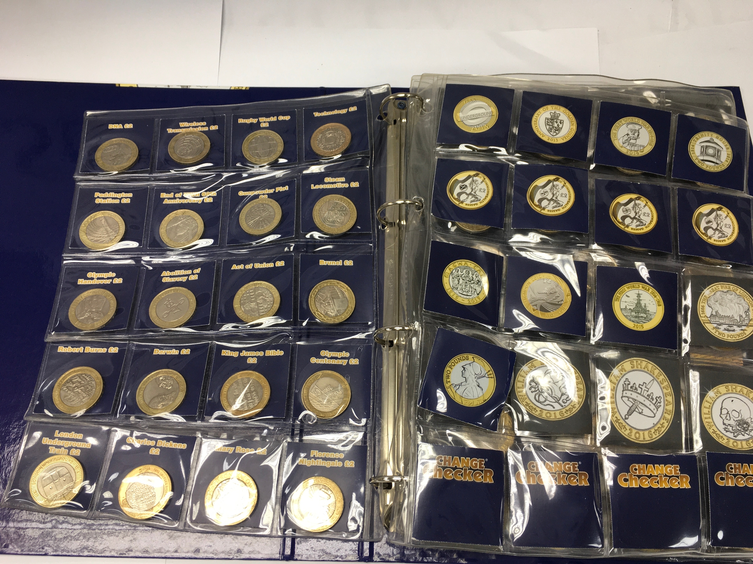 A change checker album containing various commemorative £2 coins including commonwealth's £2 coins
