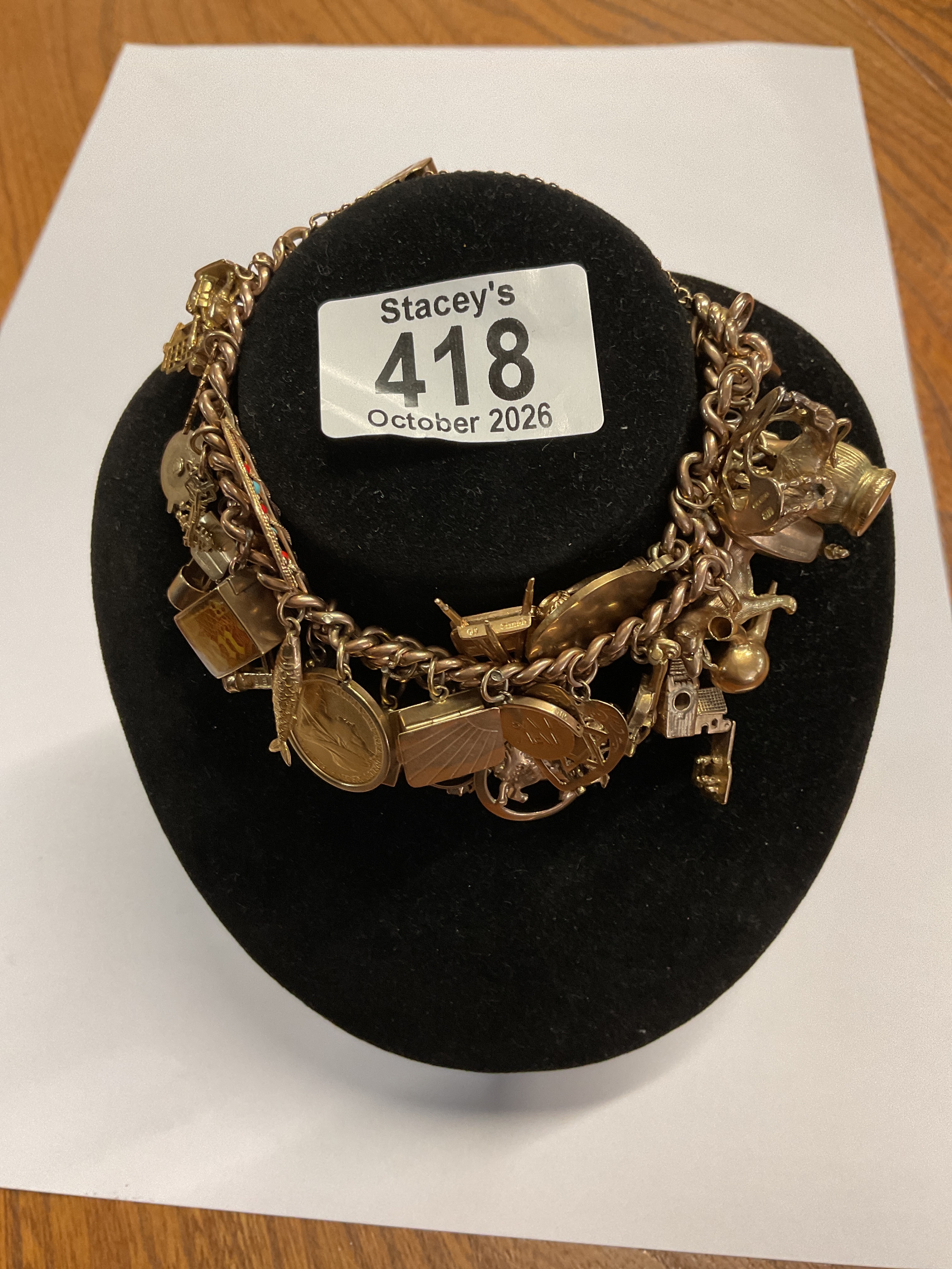 Heavy gold charm bracelet, with a half sovereign, weight 92.2 grams.