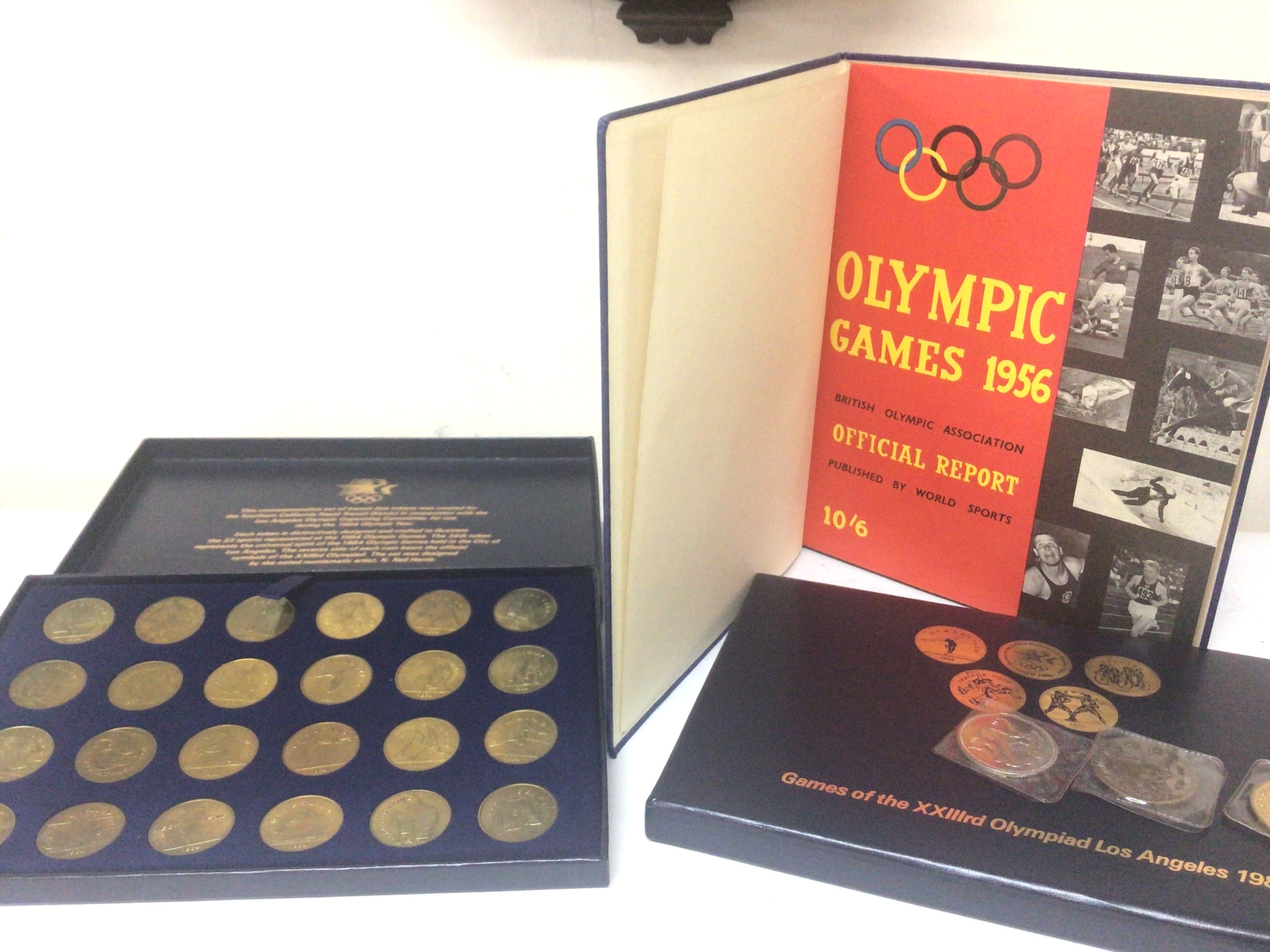 Two sets of commemorative coins Los Angeles Olympic 1984. Report from 1956 Olympic Games book and other odd coins 