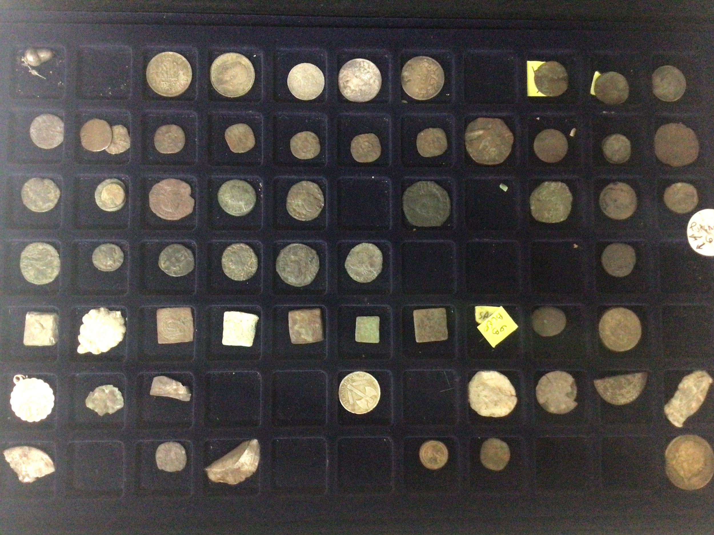  A Collectors case containing mixed metal detectors finds including some coins including Roman coins antiquity bronze buckles and other objects in trays within the case 