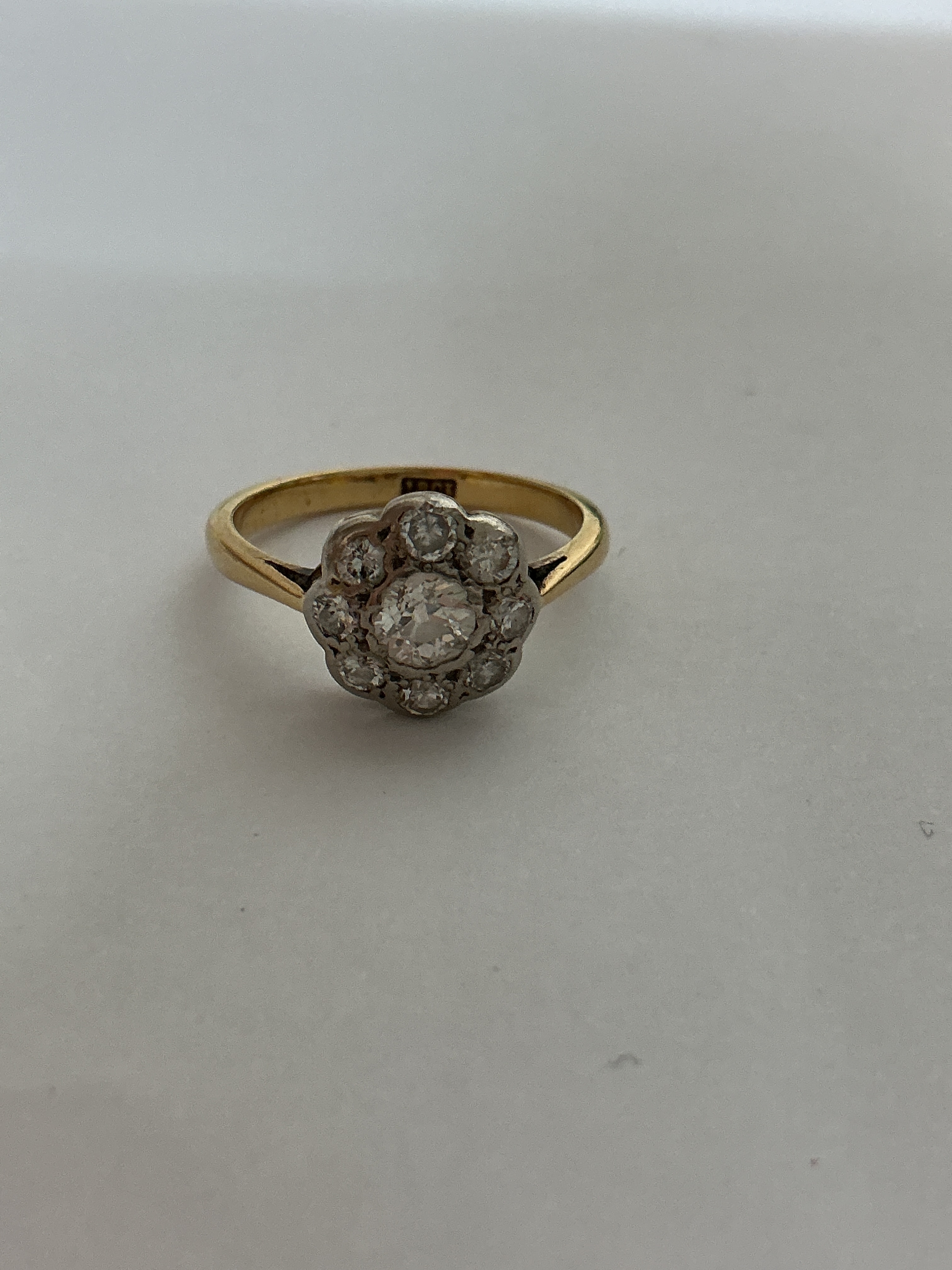 An 18ct gold and diamond ring with floral setting. Approx size M 3g